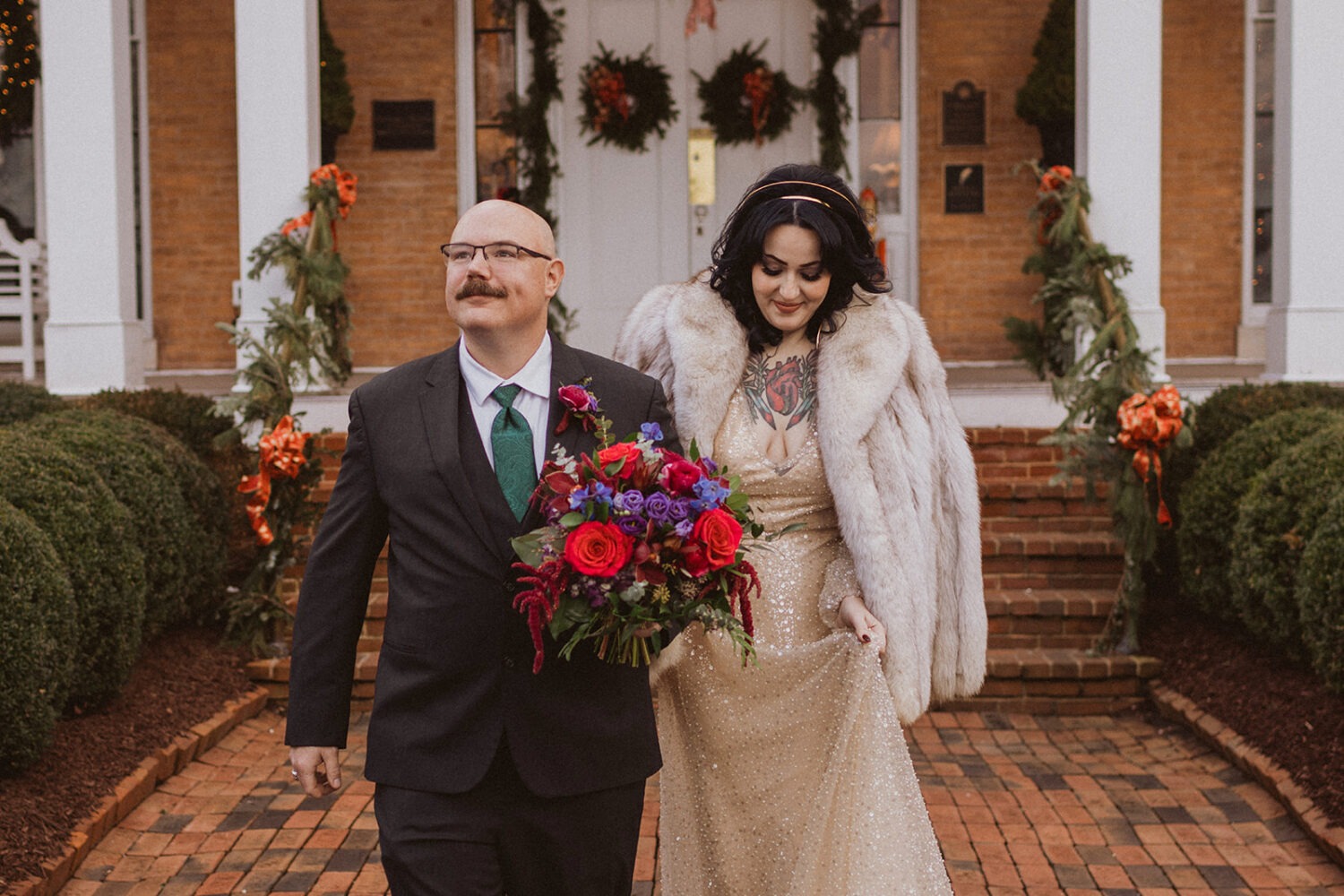 couple walking along cobblestone in front of Antrim 1944 venue