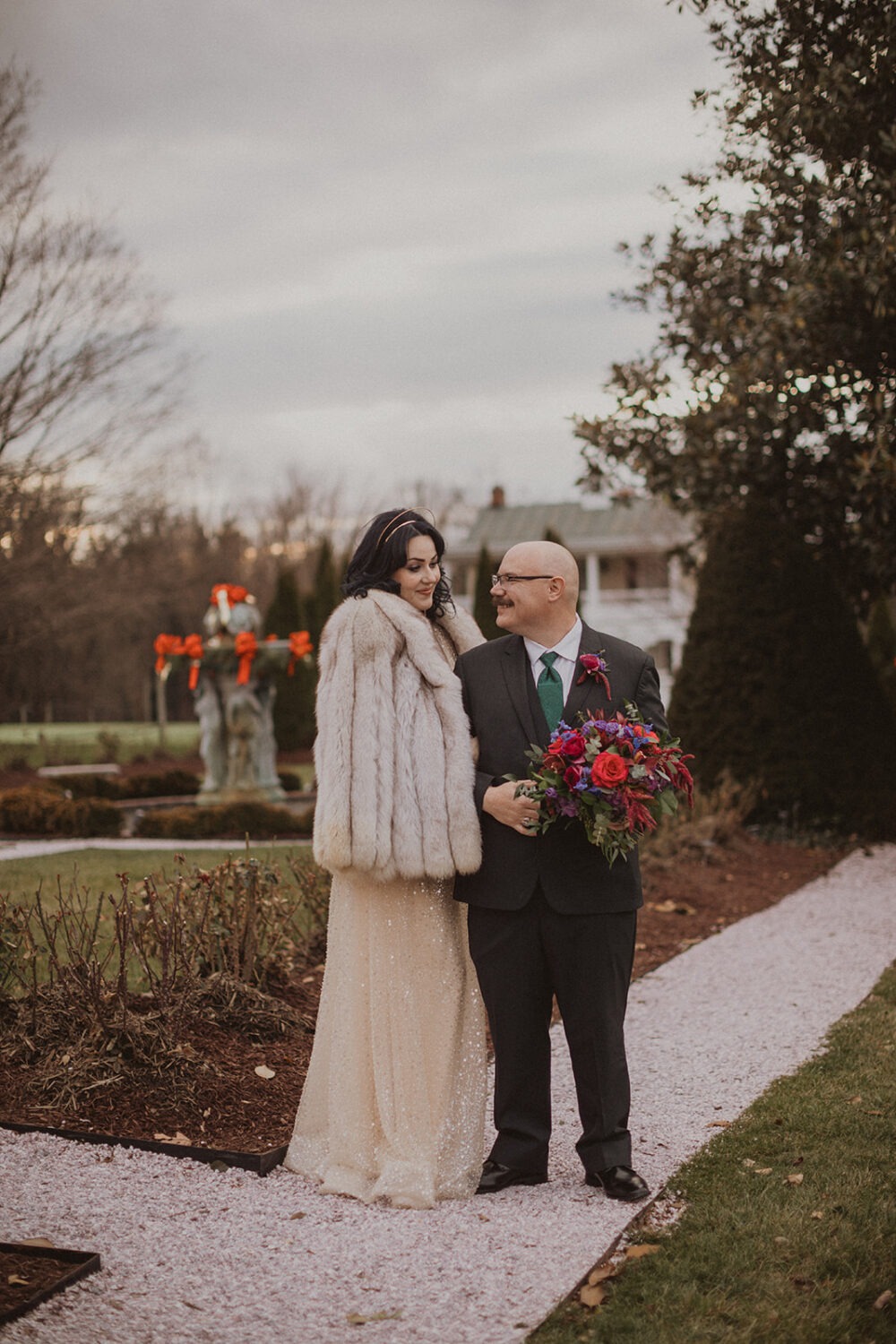 couple embrace for portrait shots showing off wedding bouquet