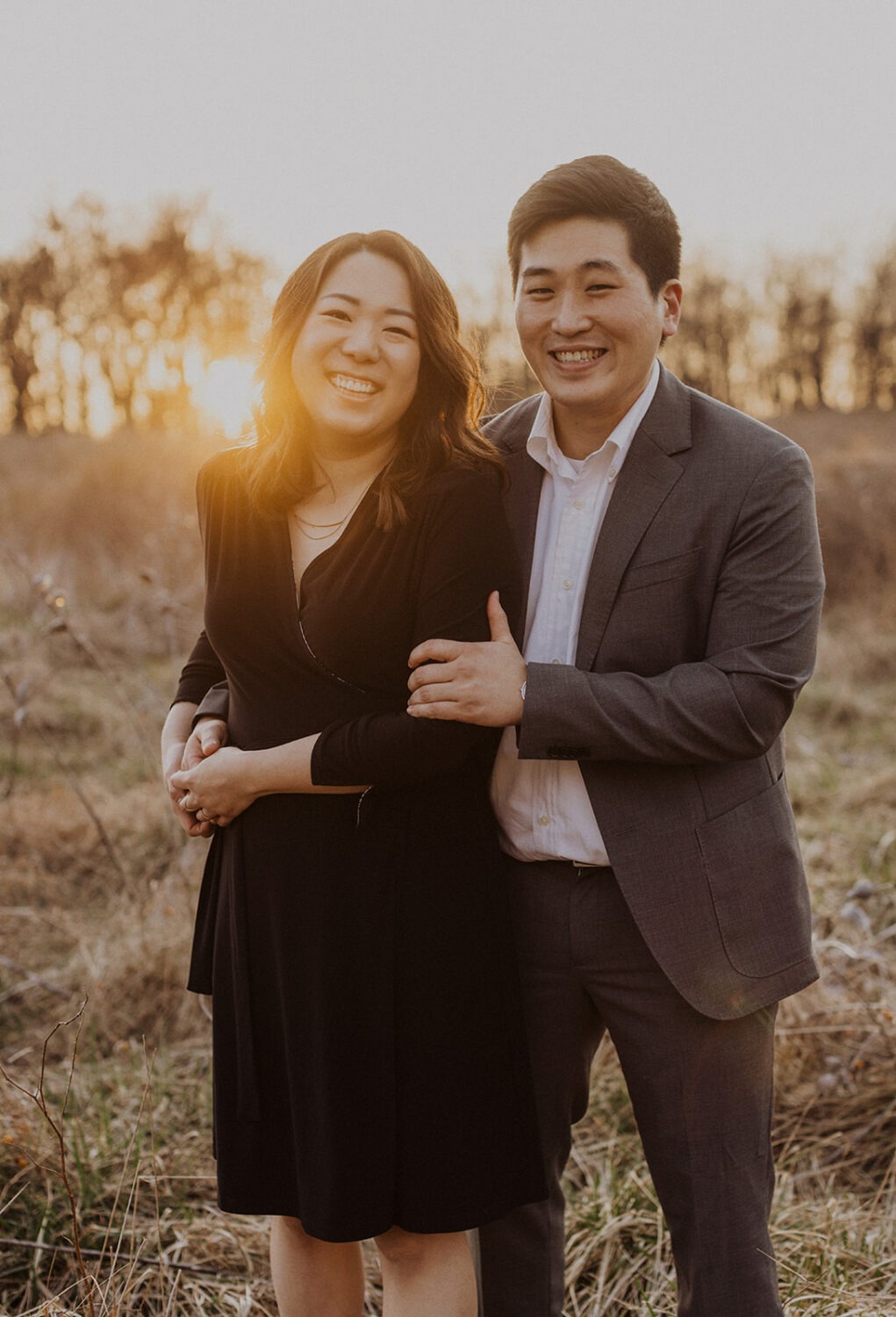couple embrace while taking winter engagement photos at Rock Creek Park
