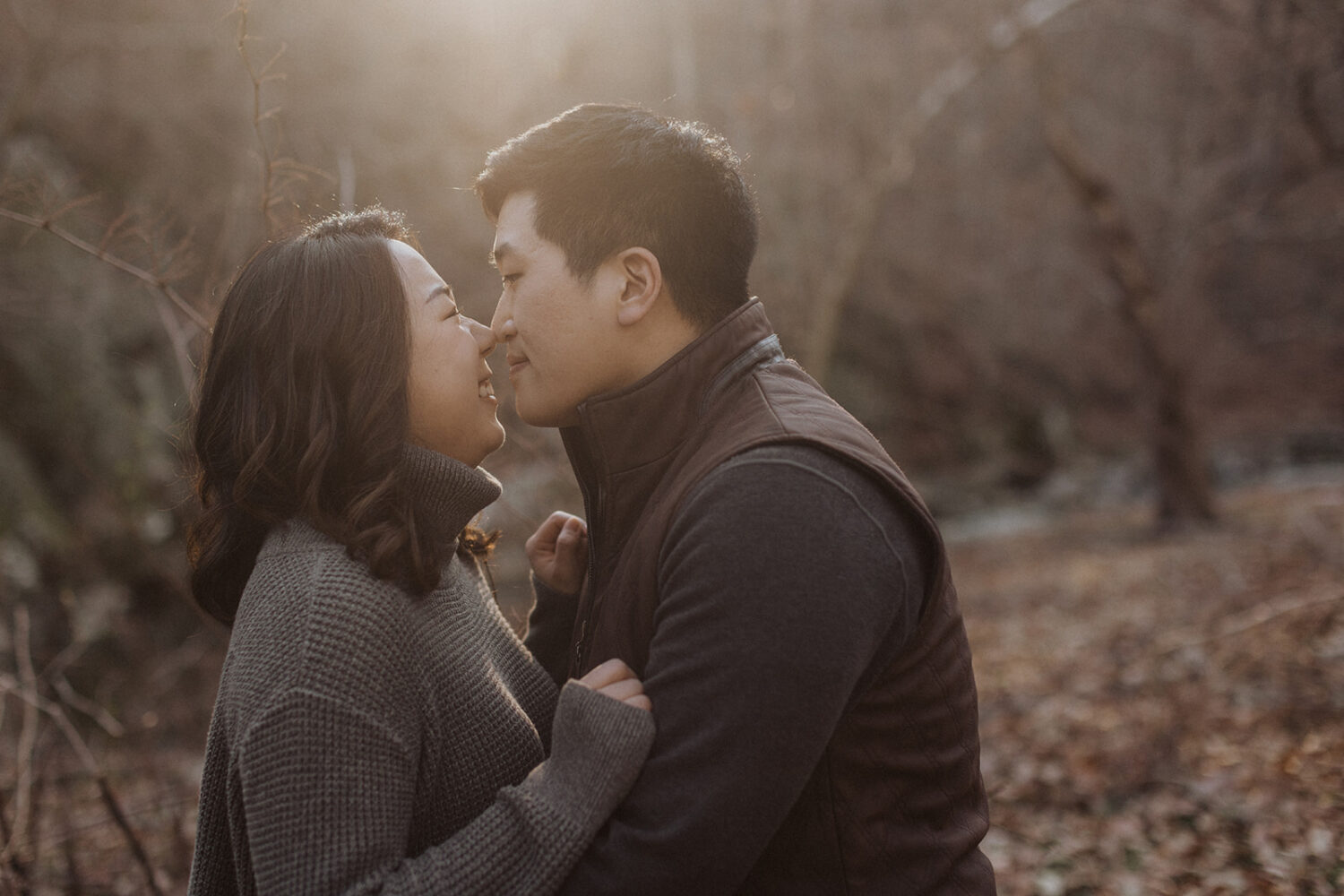 couple embrace while taking winter engagement photos