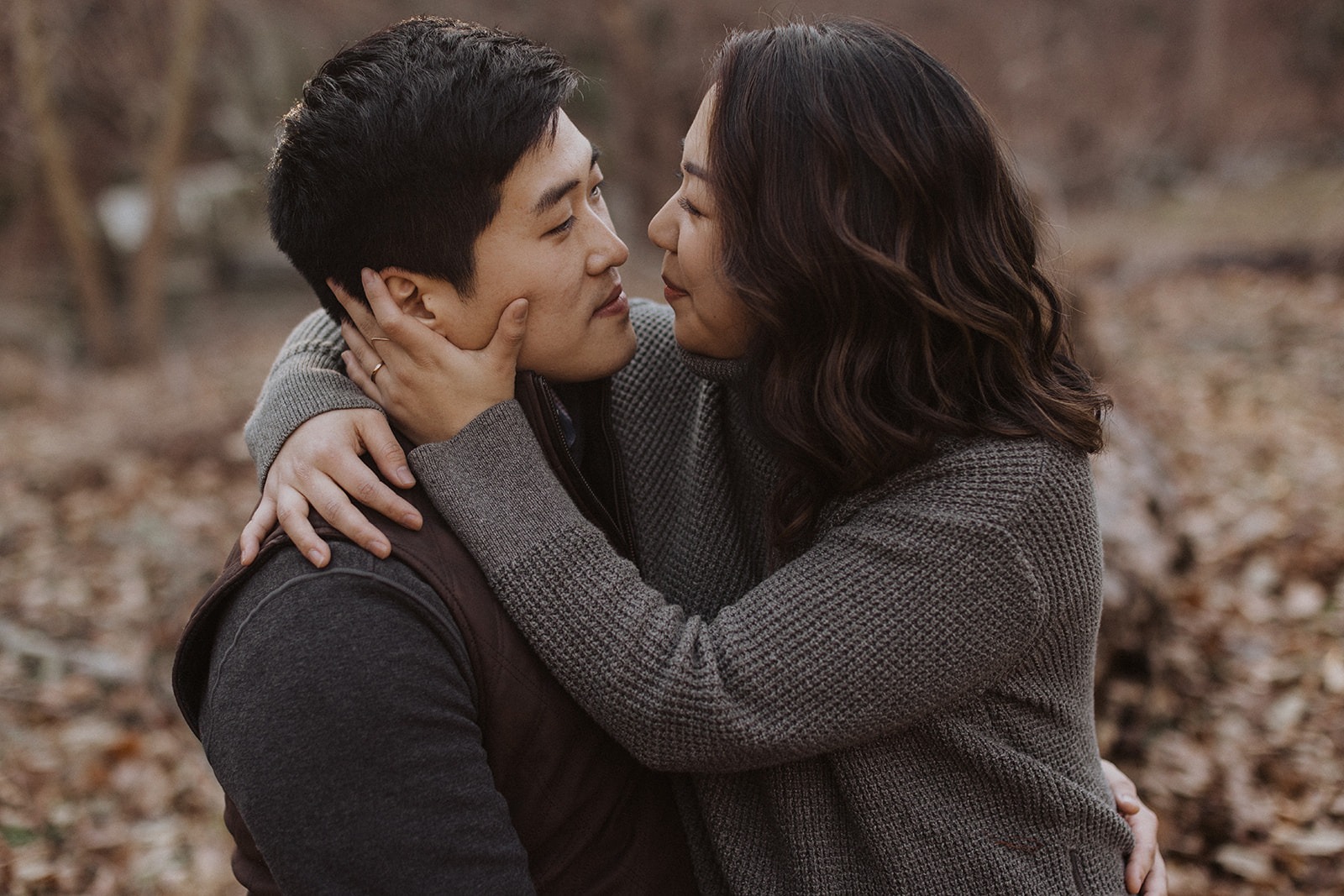 couple embrace during winter engagement photos