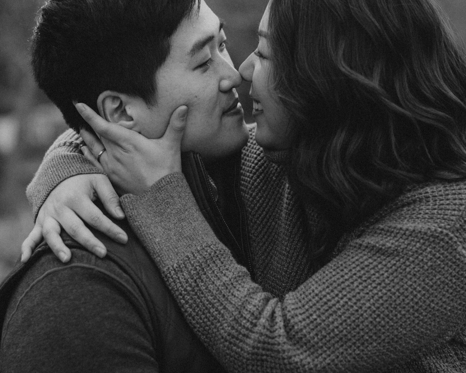 couple embrace while taking winter engagement photos