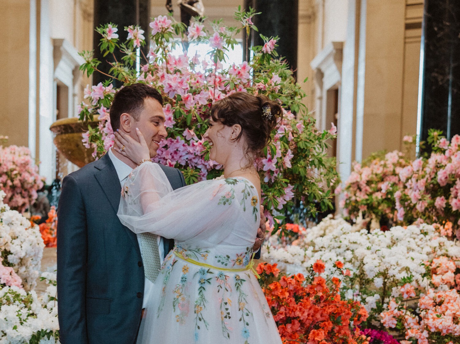 couple poses in front of flowers at National Gallery of Art