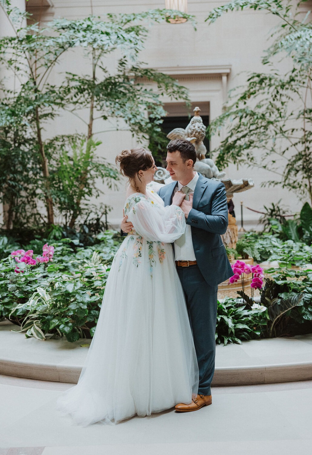 couple poses in front of flowers at National Gallery of Art