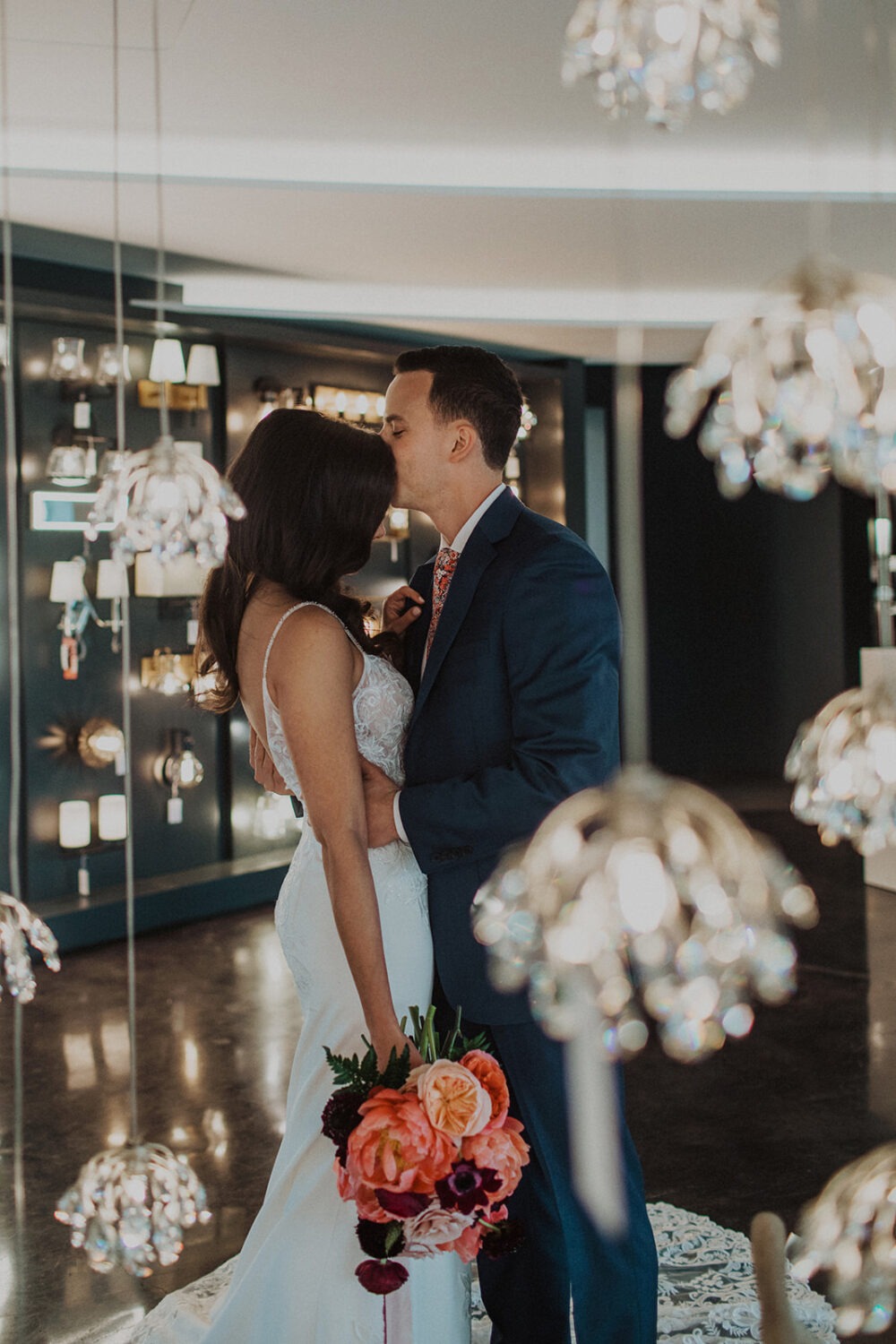 couple kiss among the hanging lights in Dominion Lighting
