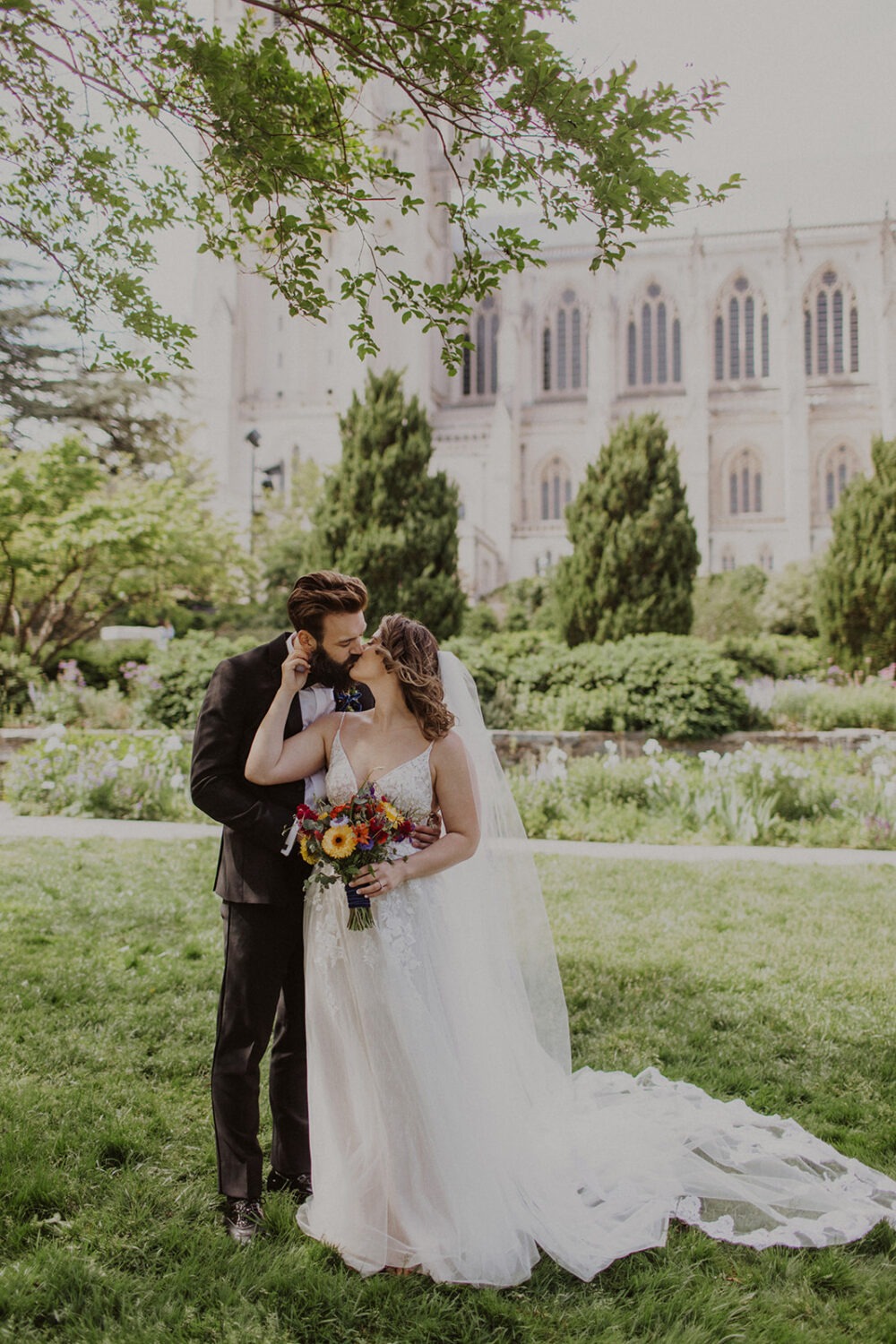 couple kisses in front of the National Cathedral