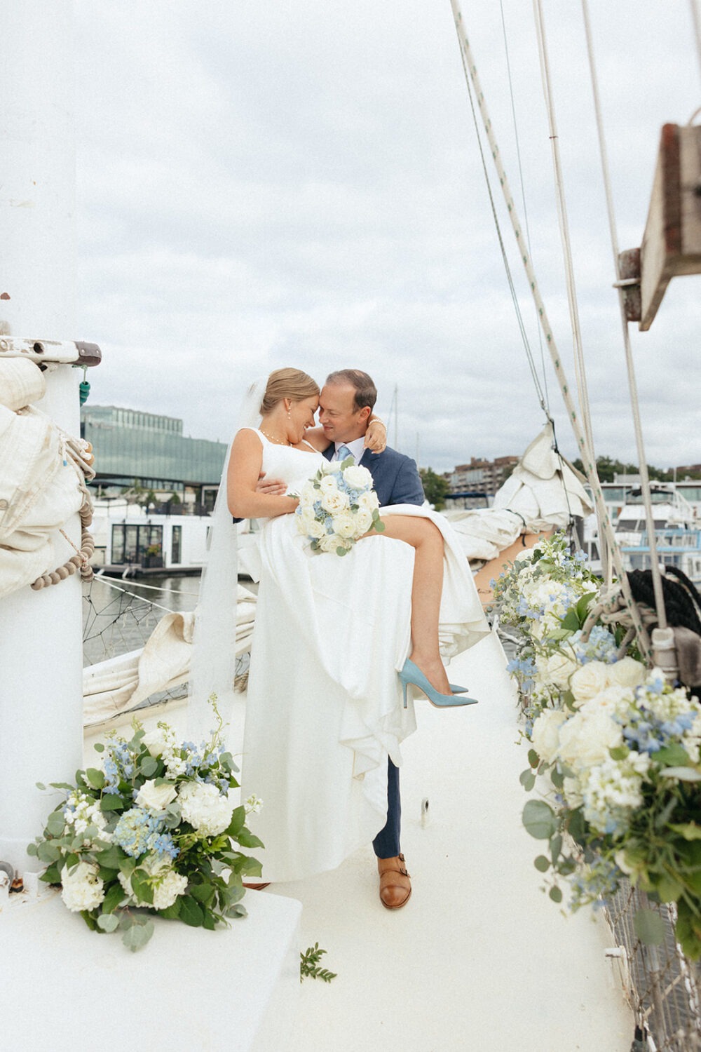 groom carrying bride on the boat