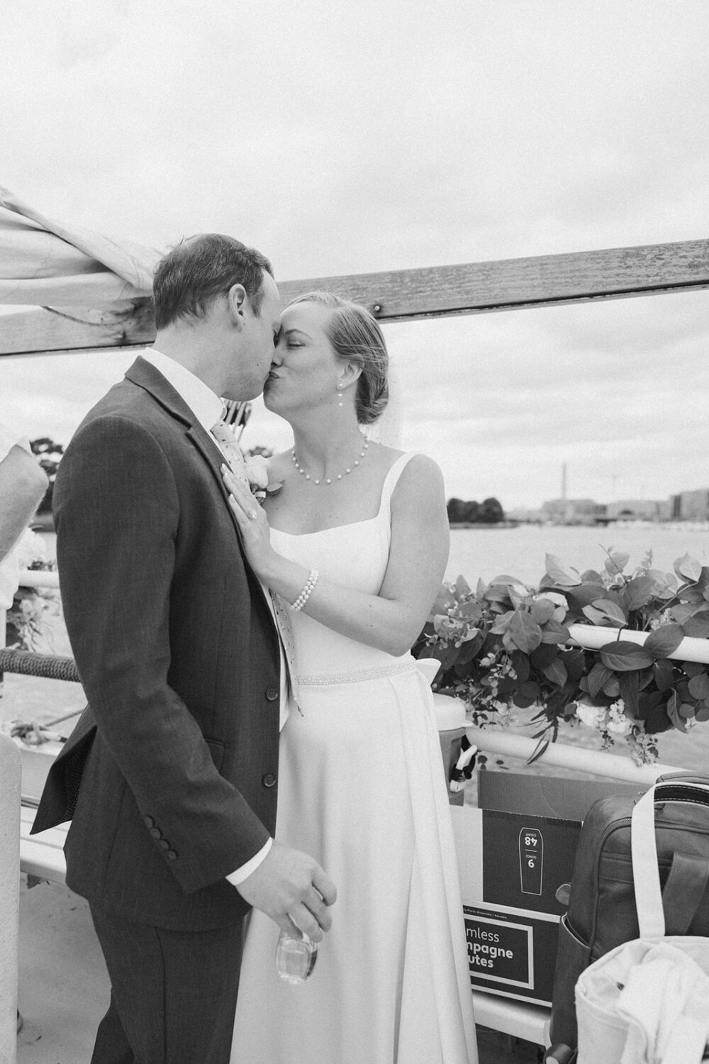 couple kiss during boat wedding