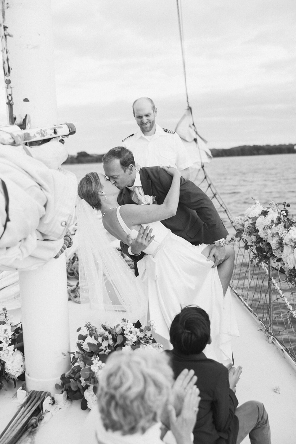 couple kiss during boat wedding ceremony