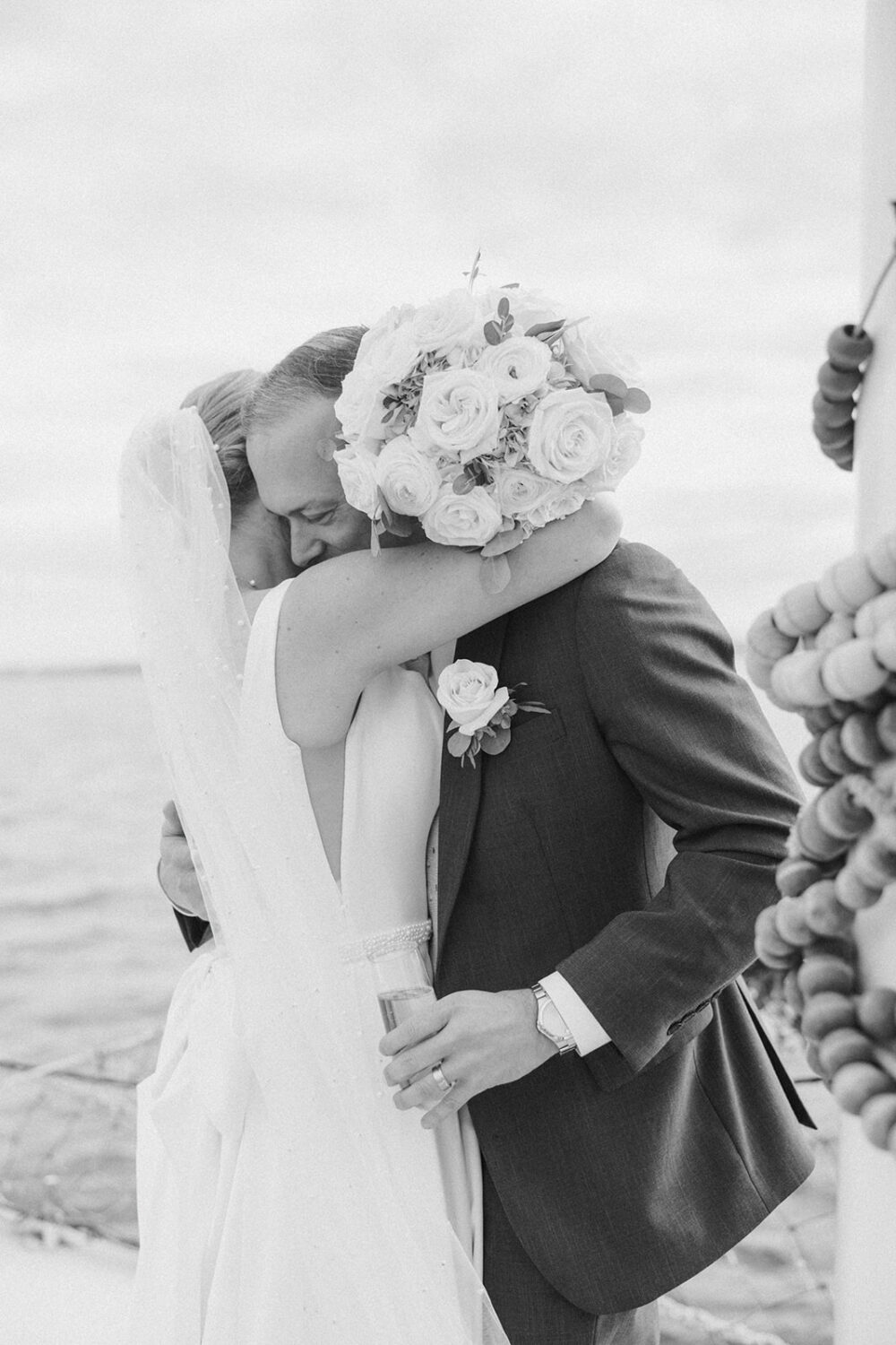 couple embrace during boat wedding
