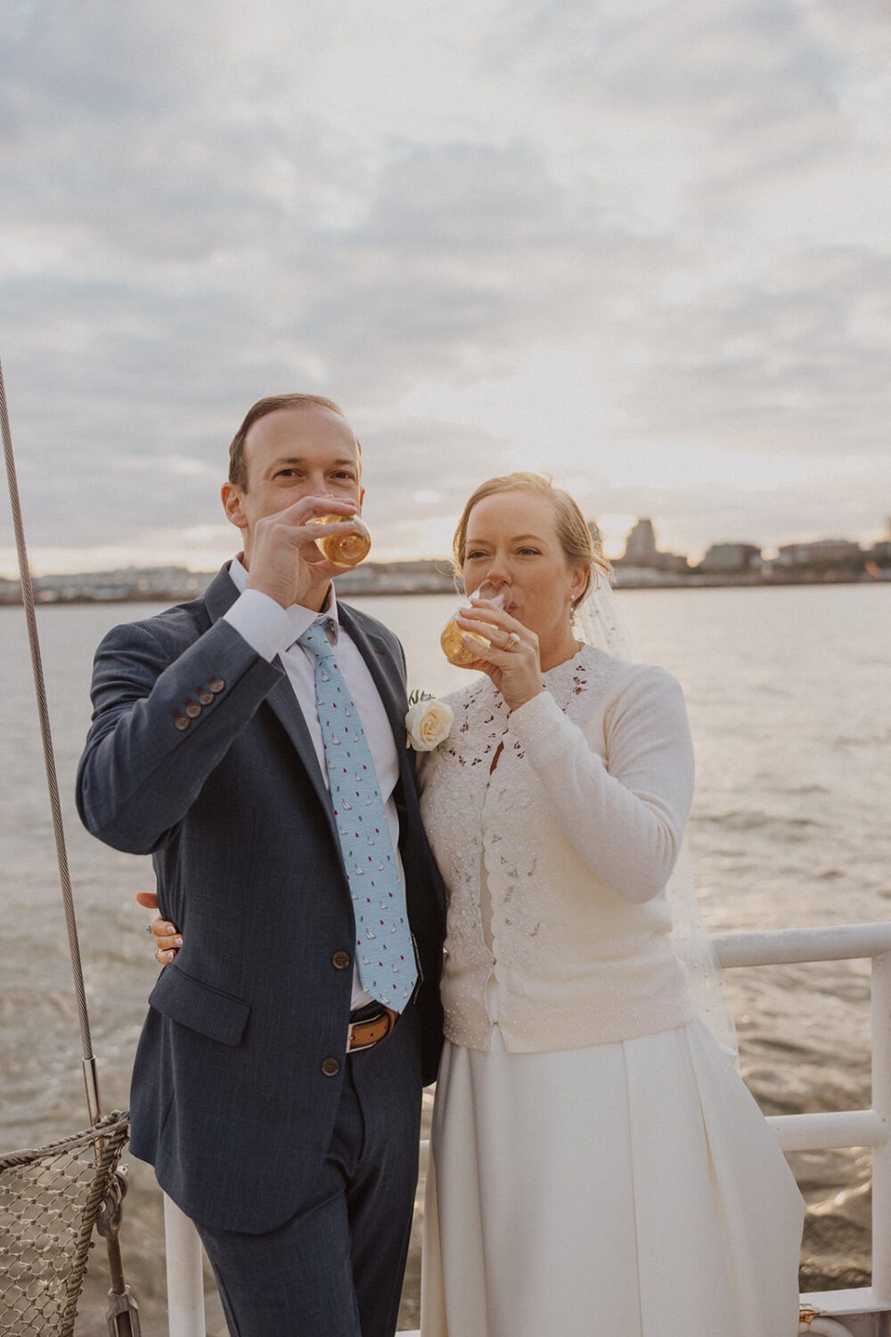 couple drink champagne celebrating their boat wedding