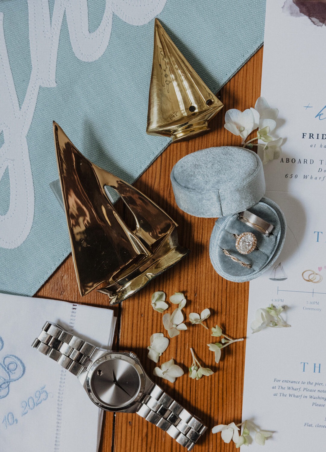 wedding flat lay including blue and white details and sailboats