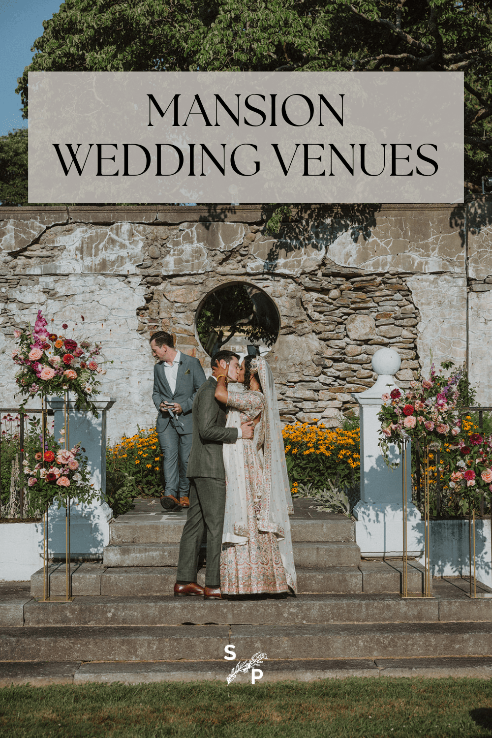 couple kiss during mansion wedding ceremony