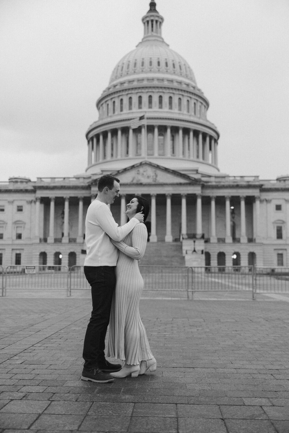 couple embrace in front of Capitol Hill DC