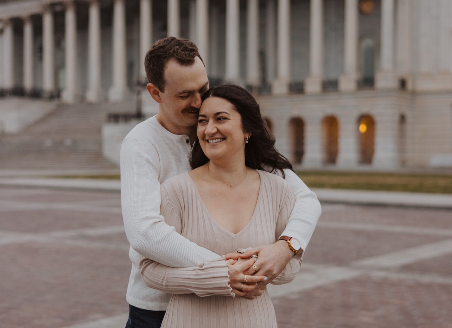 couple embrace in front of Capitol Hill DC
