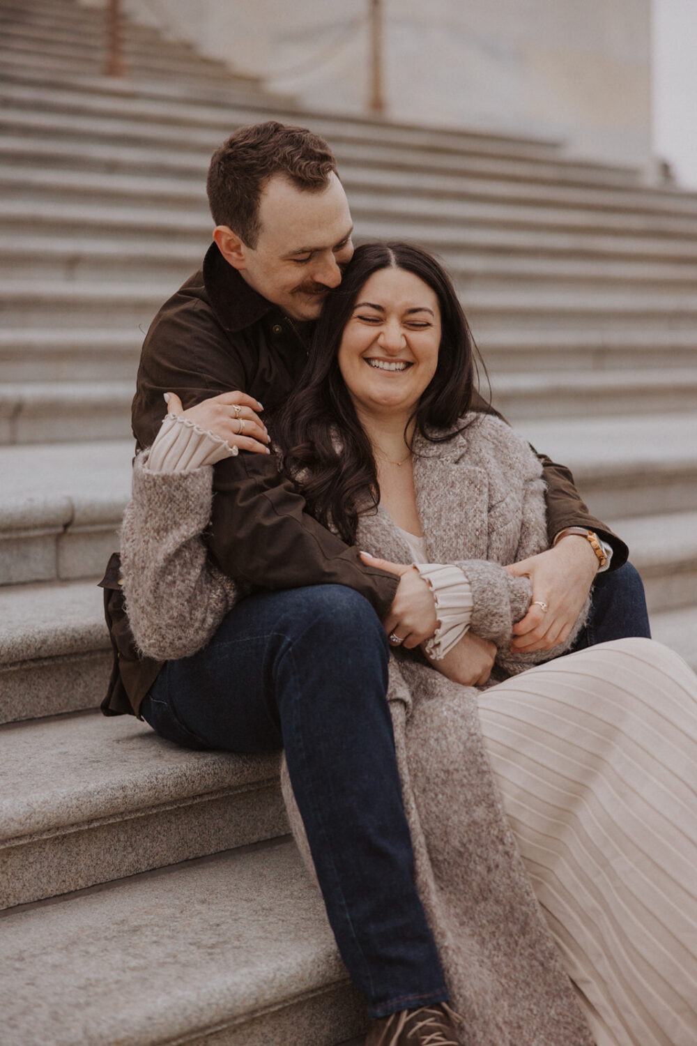 couple embrace on the steps of Capitol Hill DC