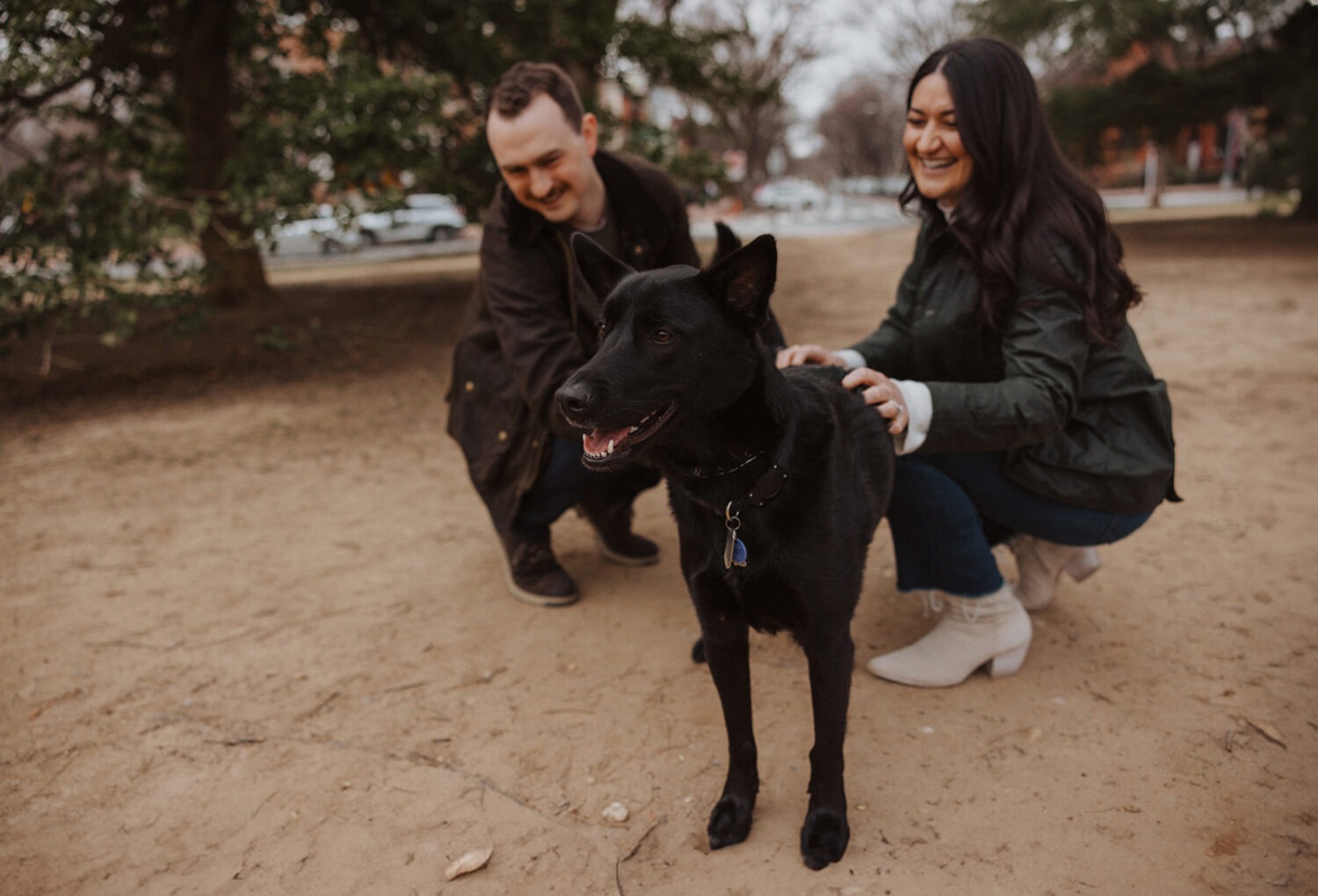 couple poses with their dog during engagement session