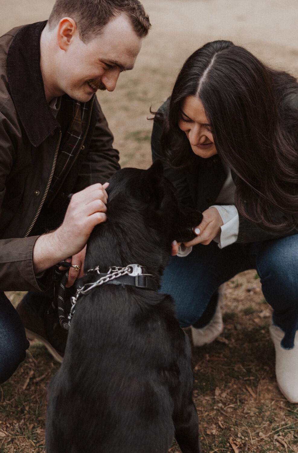 couple poses with their dog during engagement session