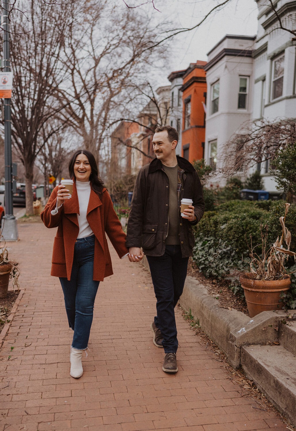 couple walking along cobblestone in Washington DC neighborhood