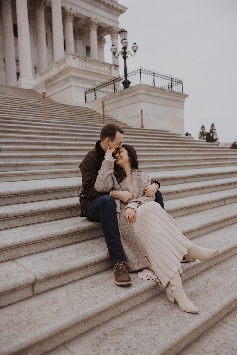 couple embrace on steps in front of Capitol Hill DC