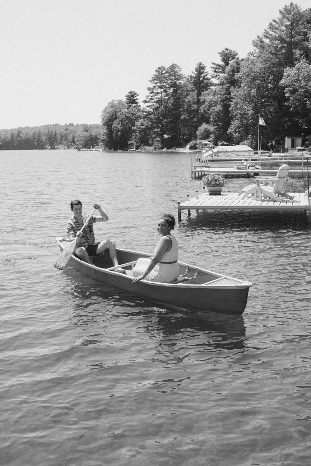 couple share a canoe on the water at the lake