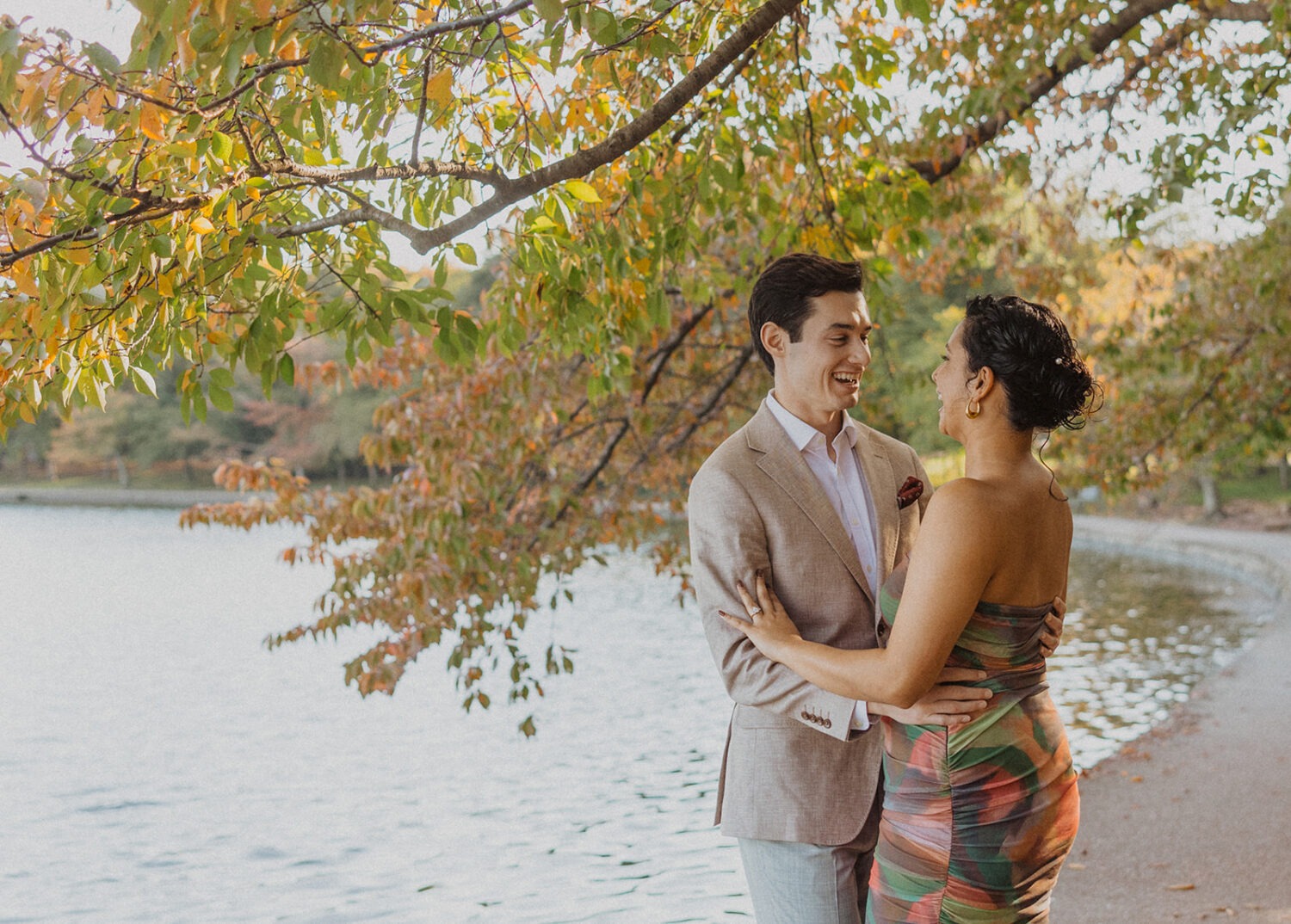 couple embrace by the water during engagement shoot