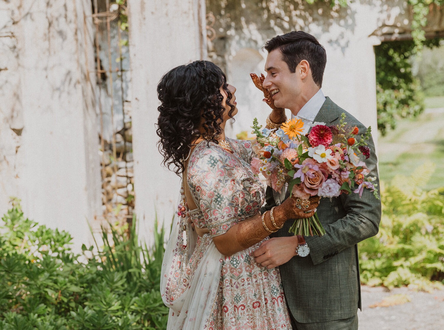 couple embrace during first look at mansion wedding