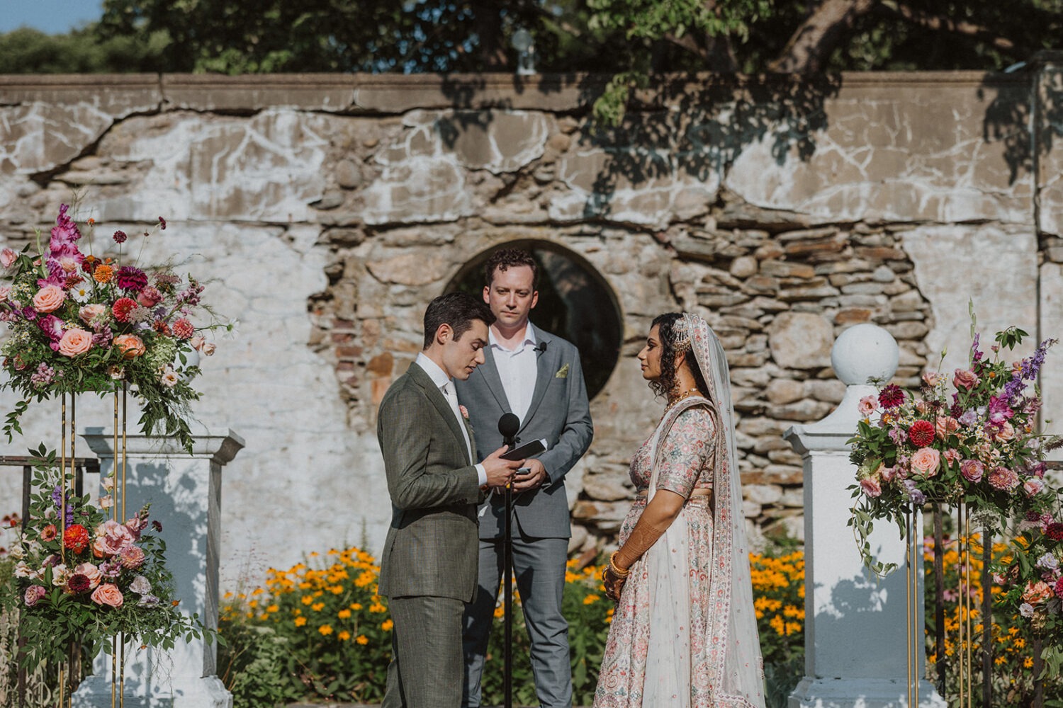 couple exchange vows during mansion wedding ceremony