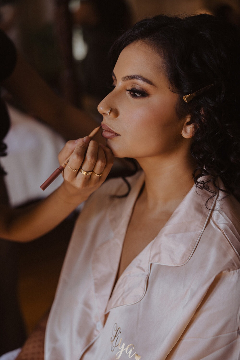 bride getting hair and makeup done