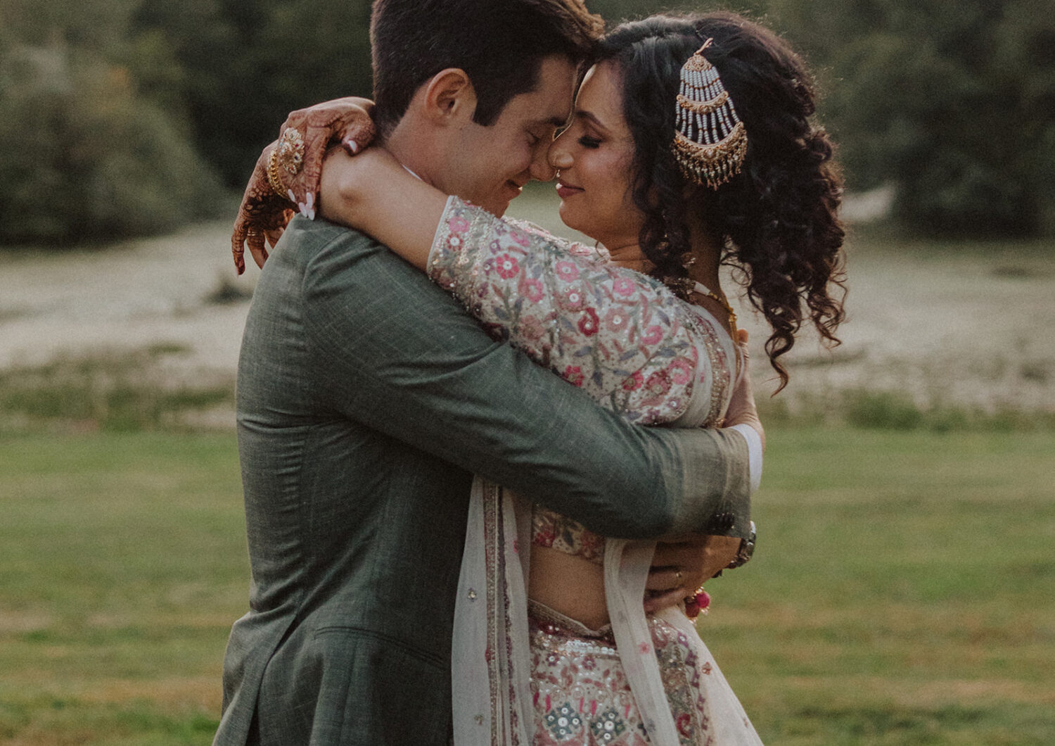 couple embrace while taking wedding portraits