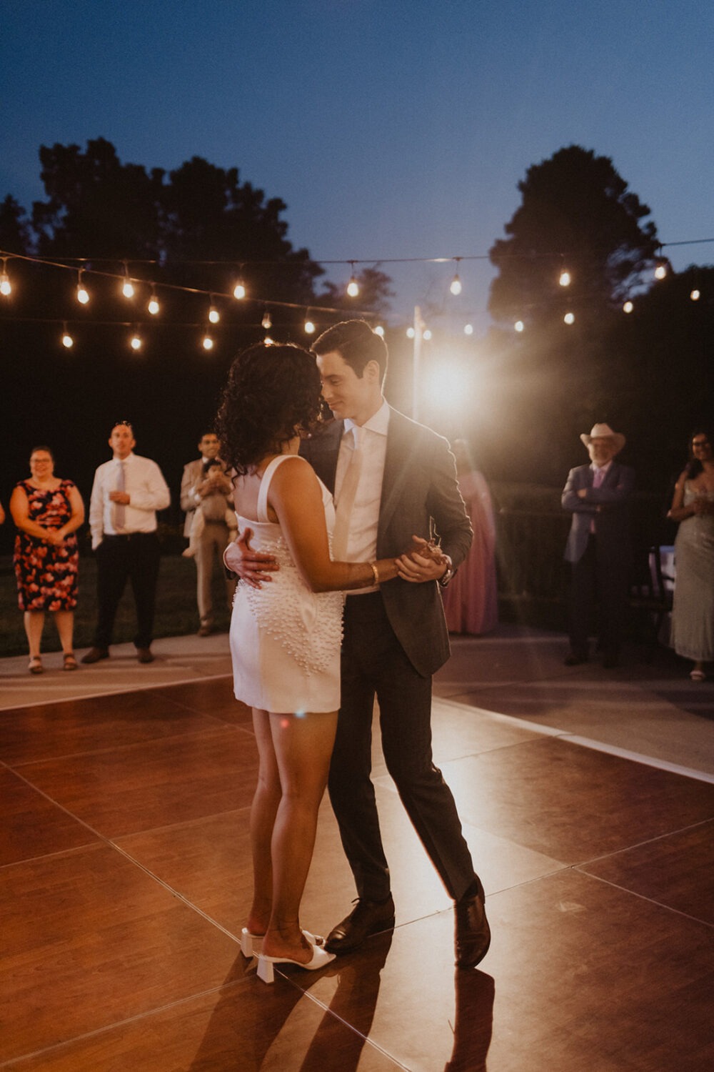 couple dance together under the night sky during mansion wedding reception