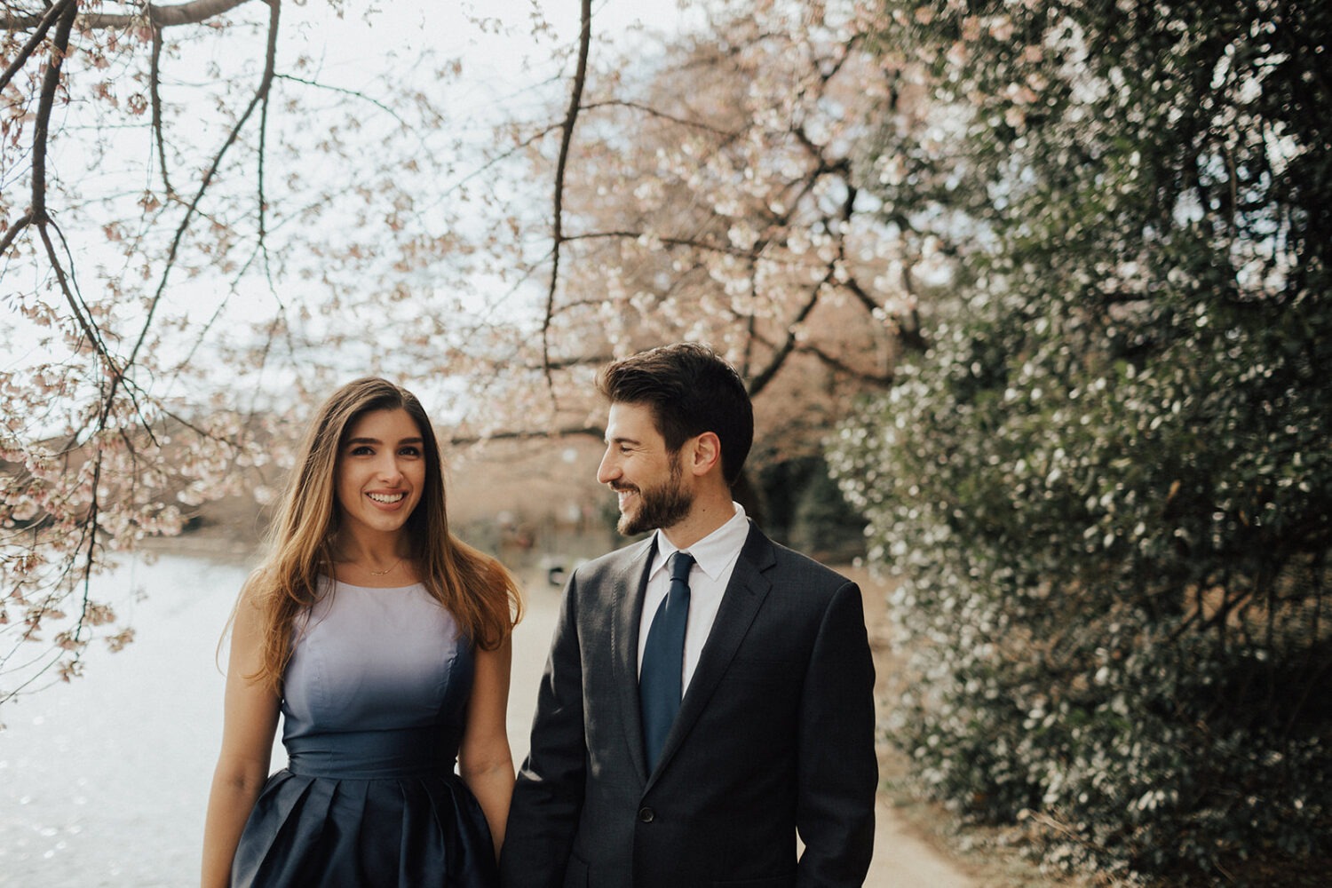 couple poses along the water