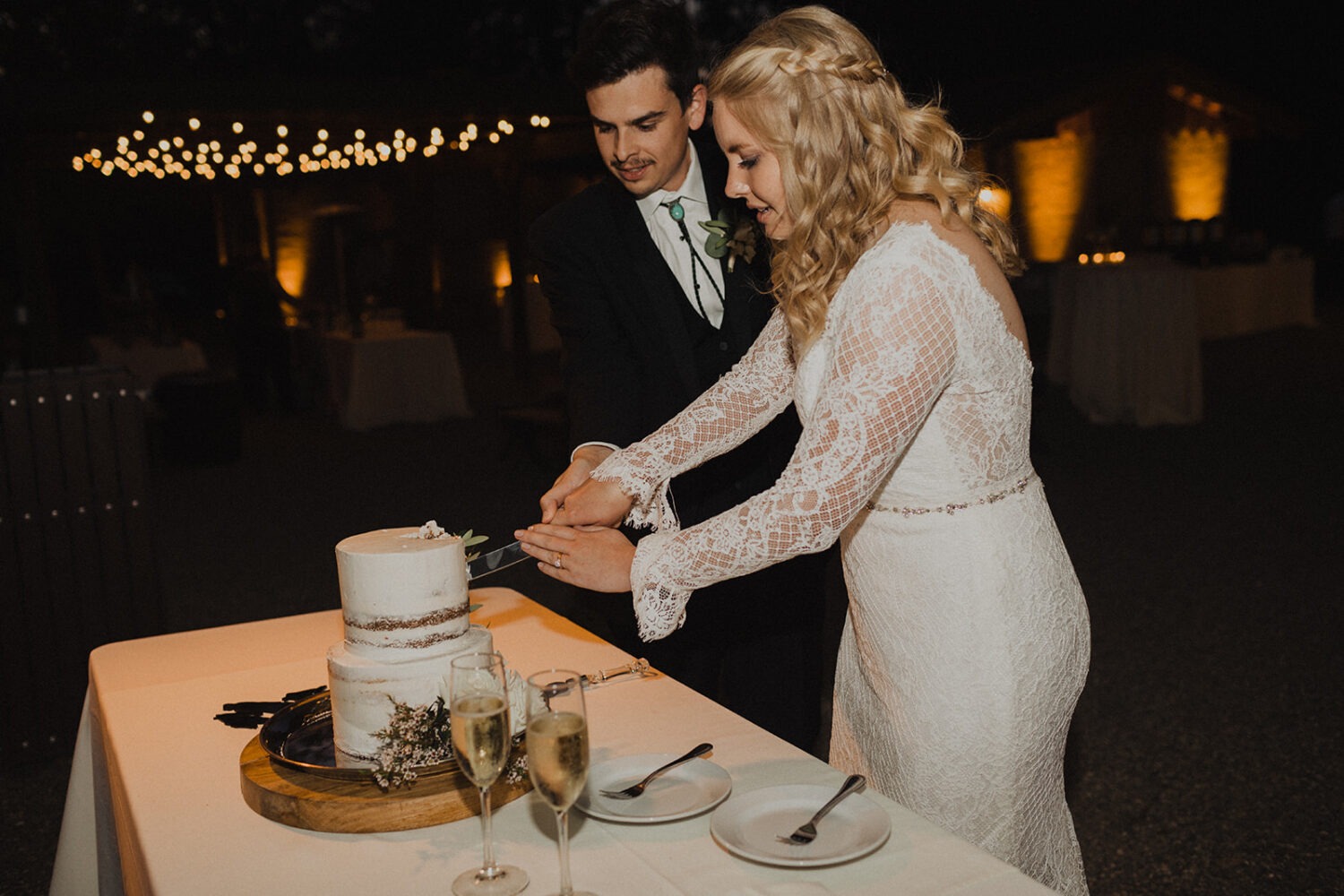 couple cutting cake during reception