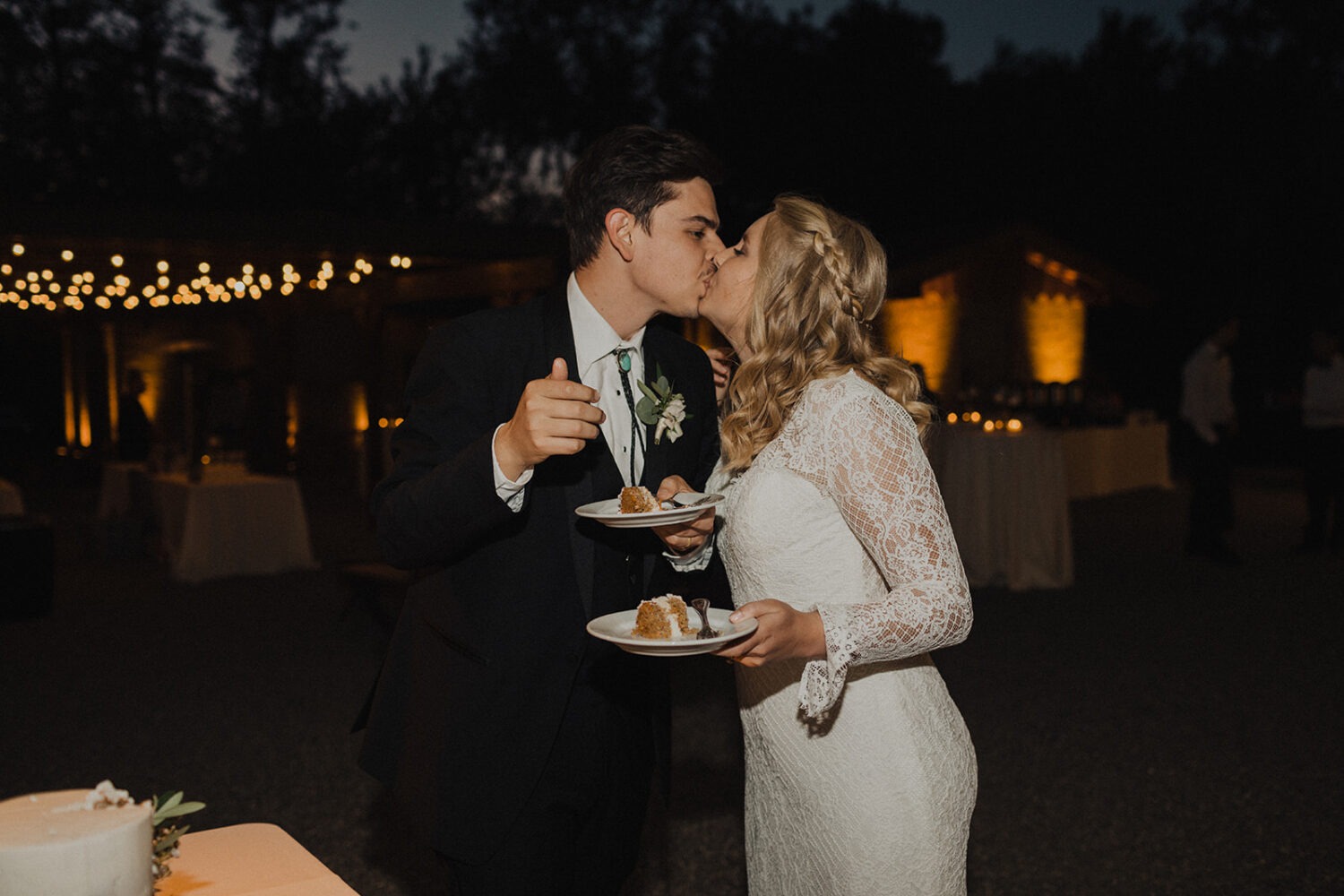 couple kiss after cutting cake