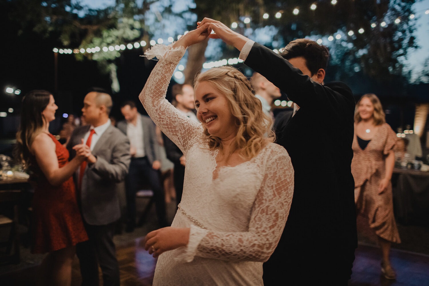 couple dancing at reception under the lights