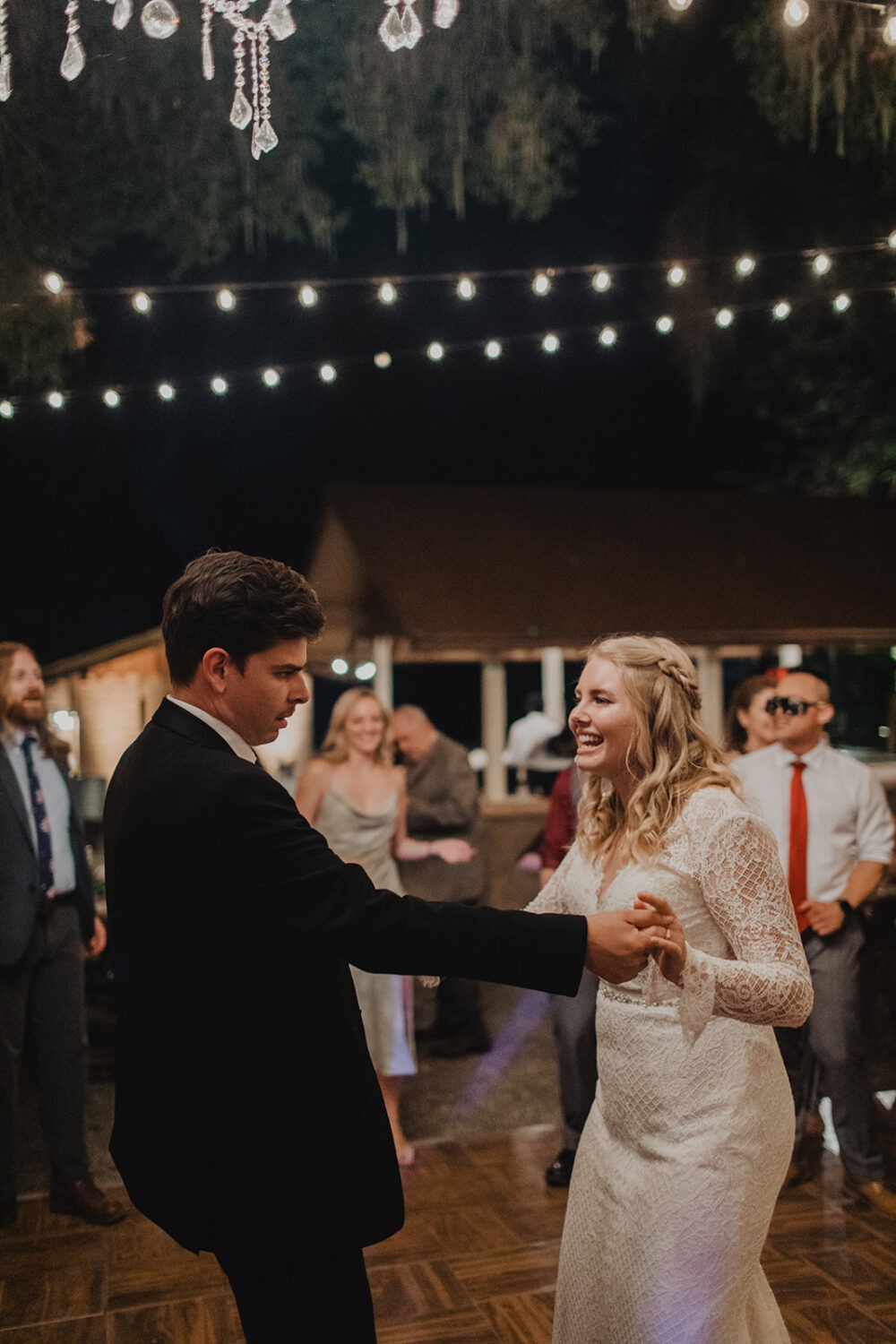 couple dancing at reception under the lights