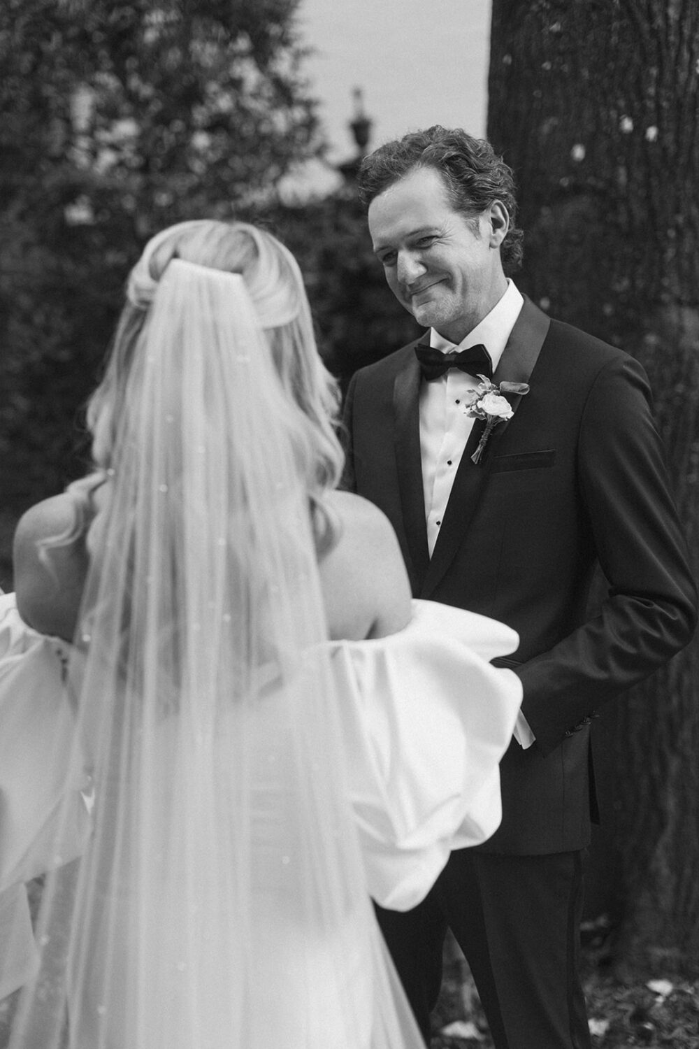 groom smiling at bride during ceremony