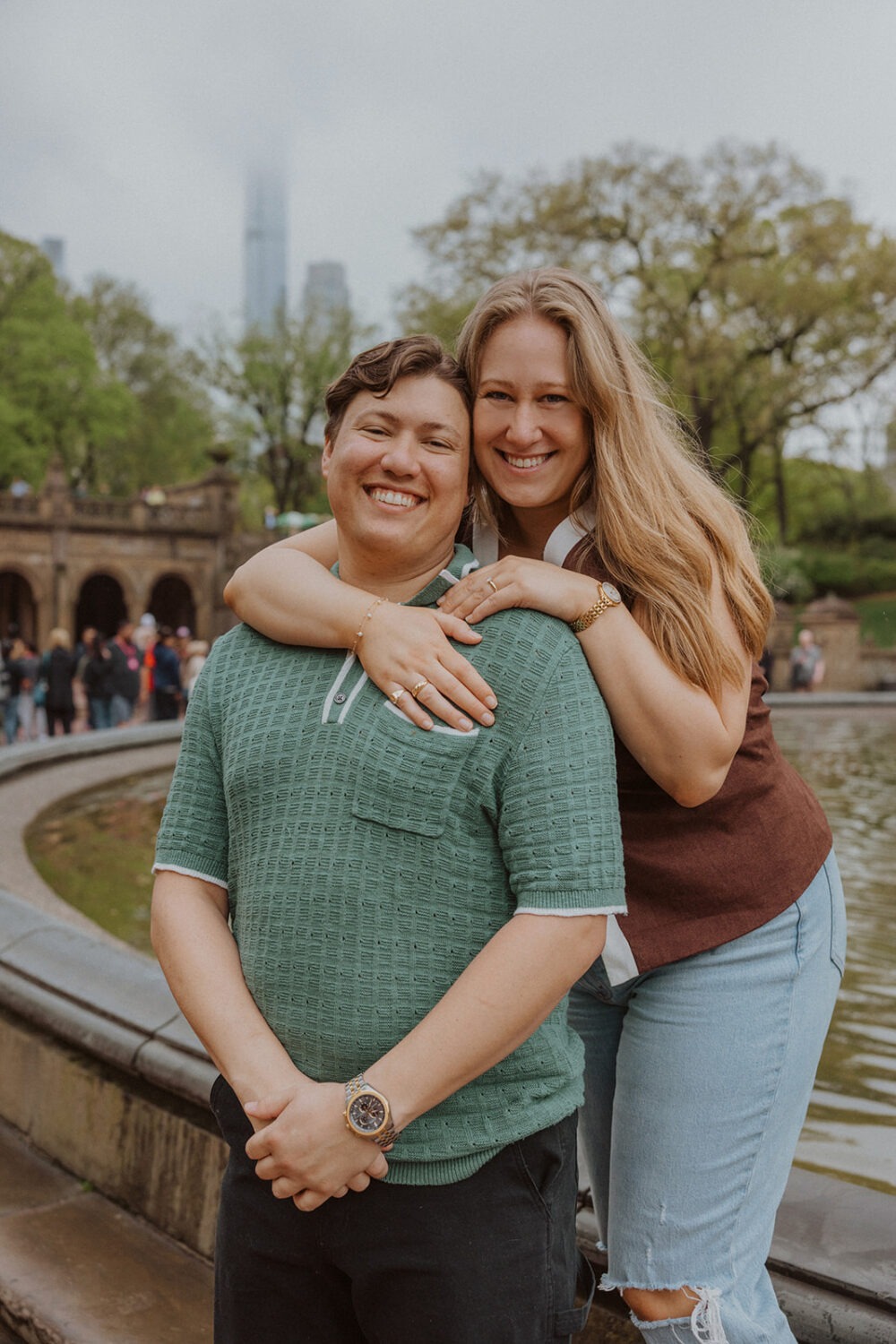 couple pose in front of the Bethesda Fountain in NYC