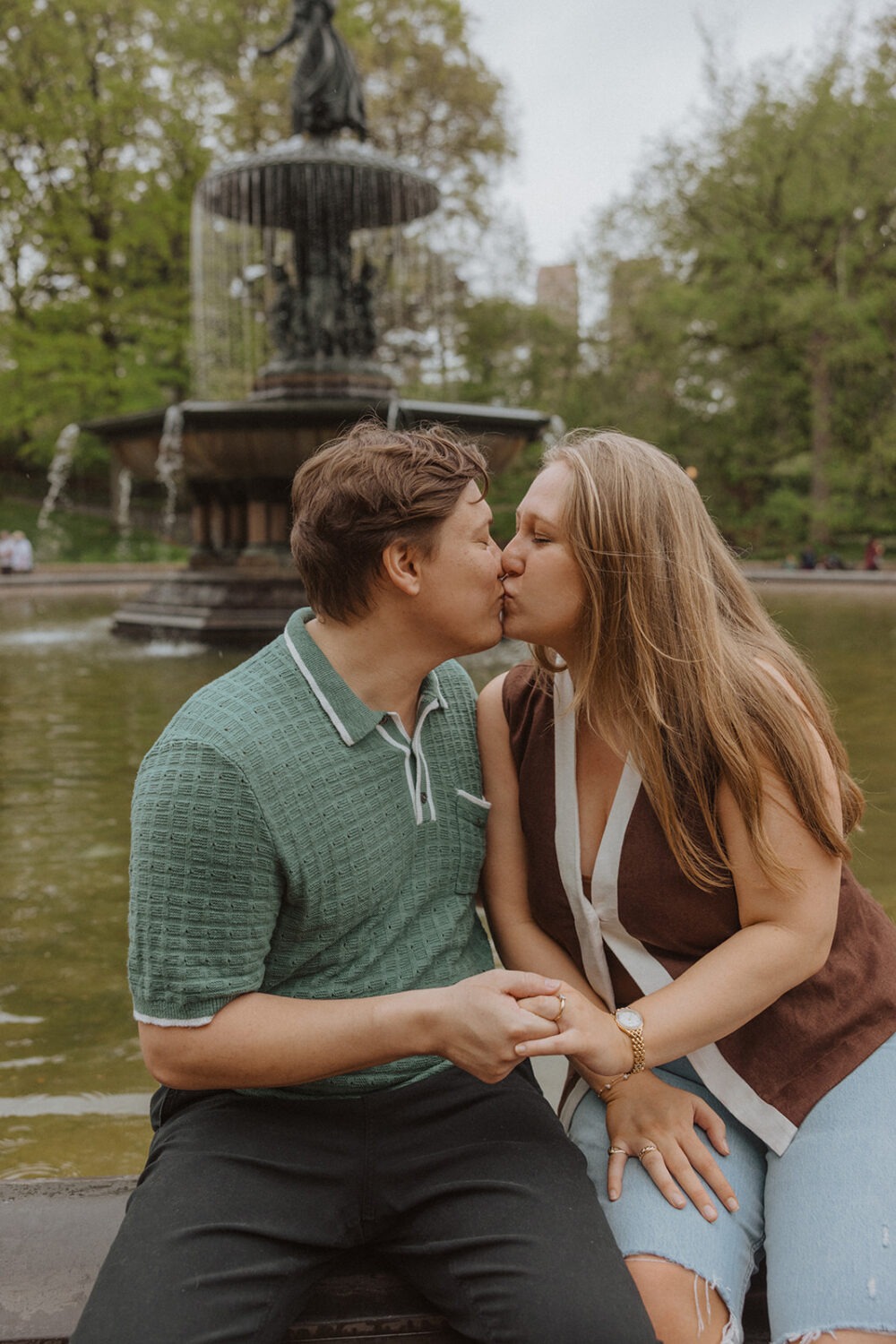 couple kiss in front of the Bethesda Fountain in NYC