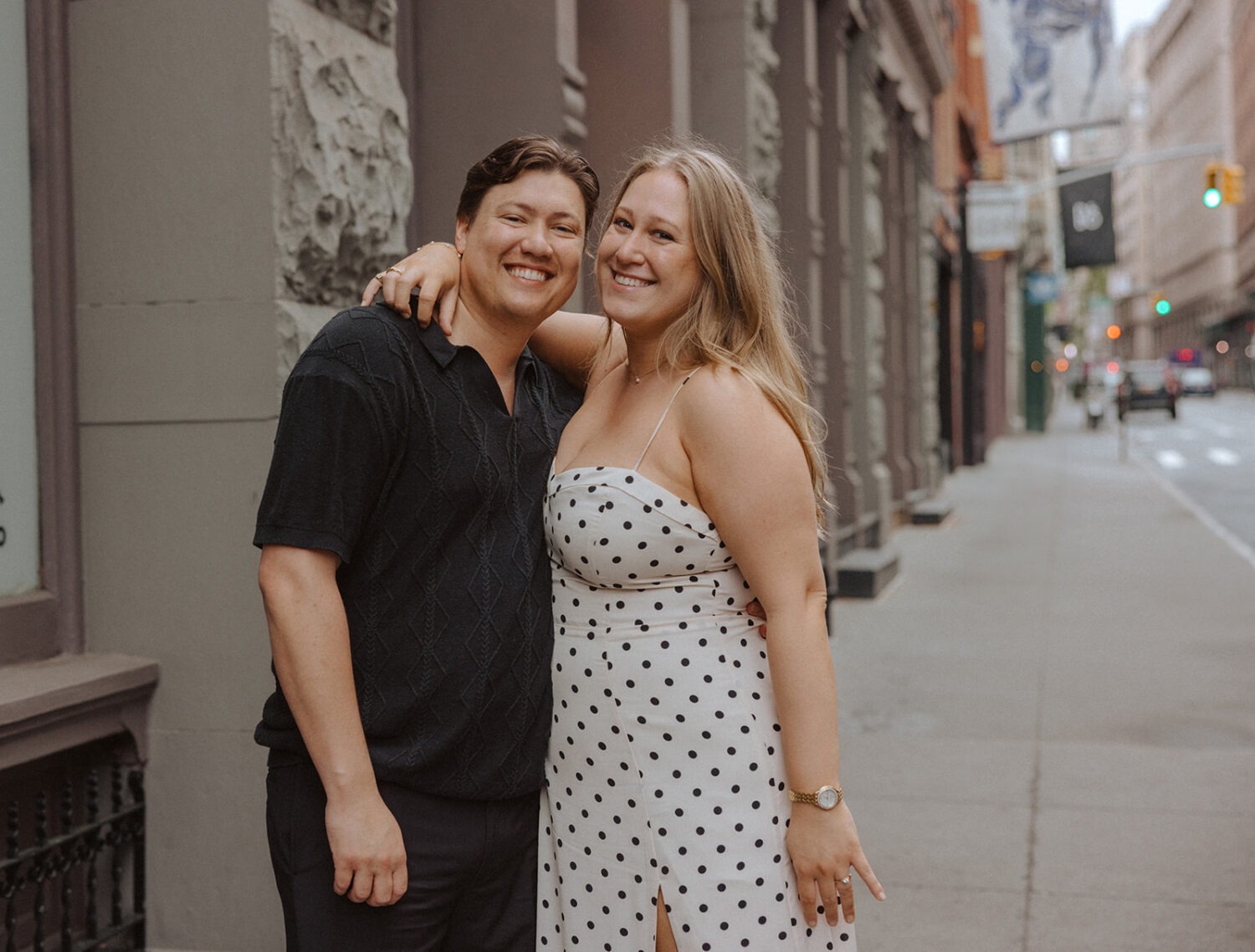 couple pose on the sidewalk of the streets of NYC