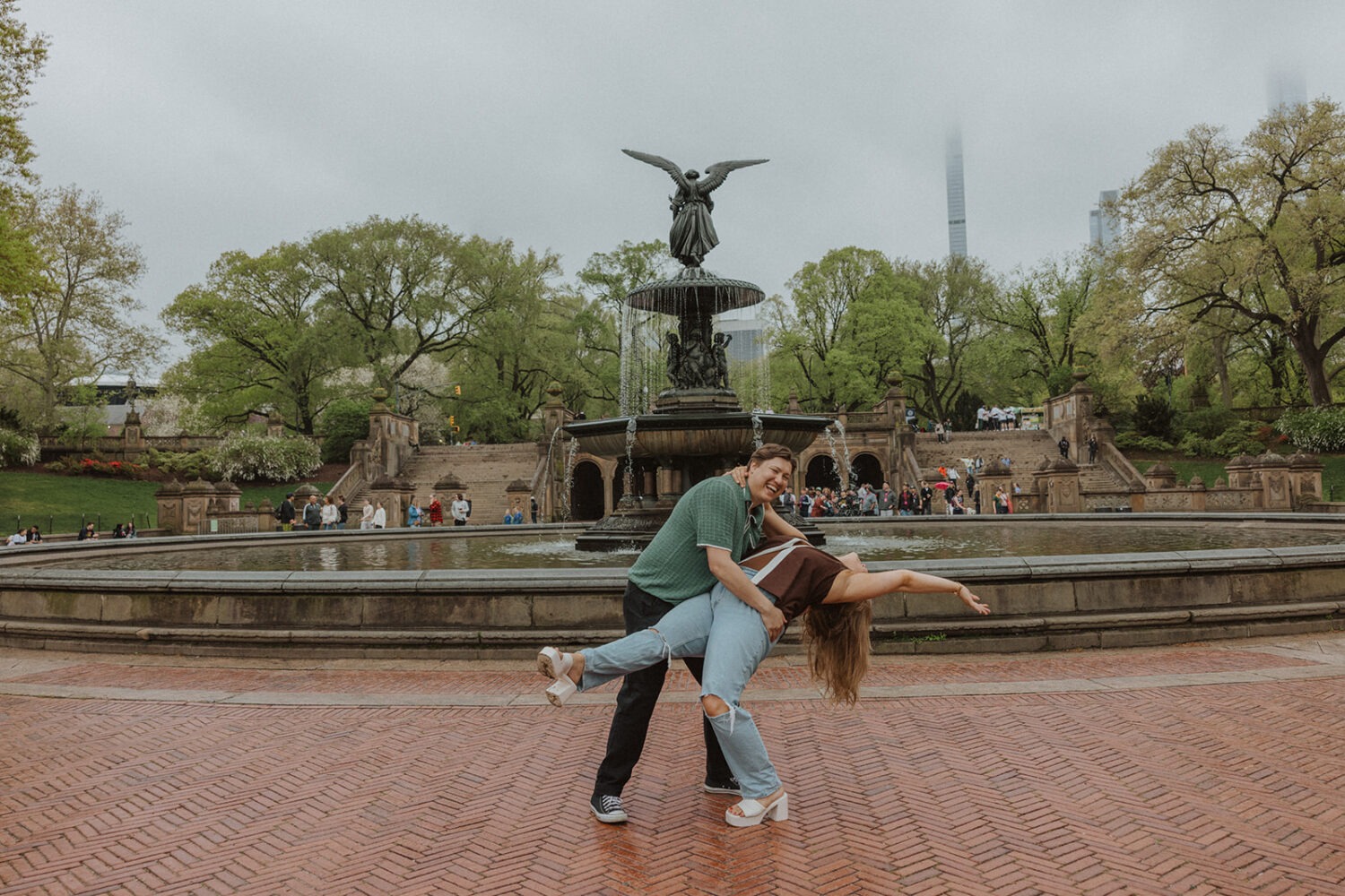 couple posing in front of Bethesda Fountain in NYC
