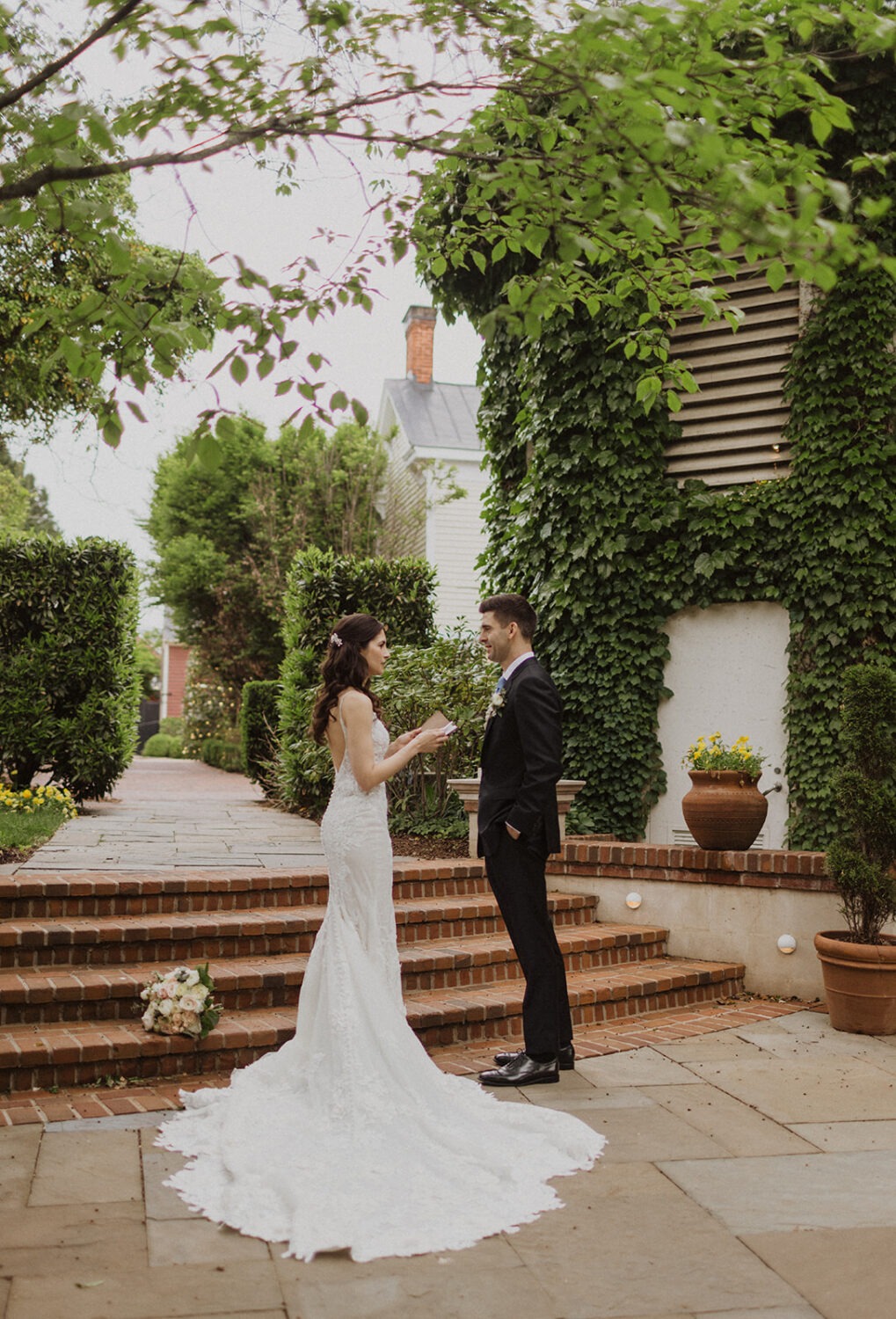 The Inn at Little Washington photos of the couple reading vows in front of brick steps