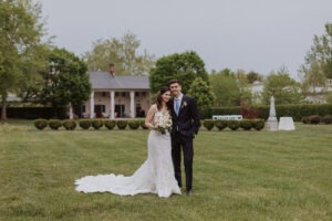 couple pose in front of building to take the inn at little washington photos