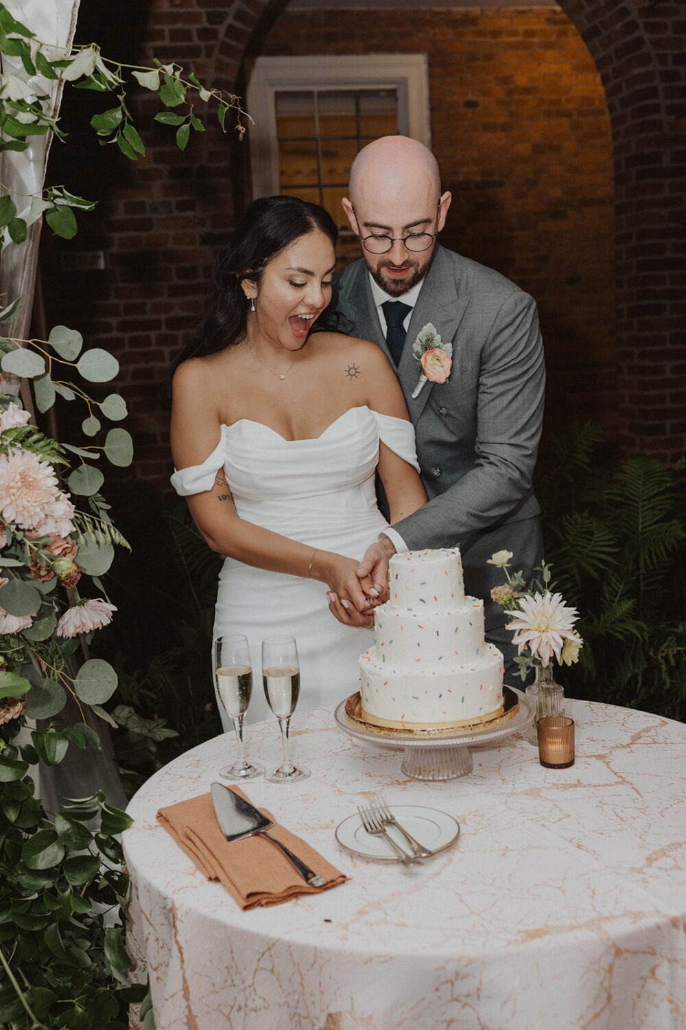 couple cutting cake together