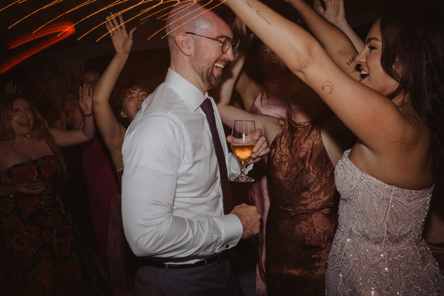 couple dance along with guests at reception
