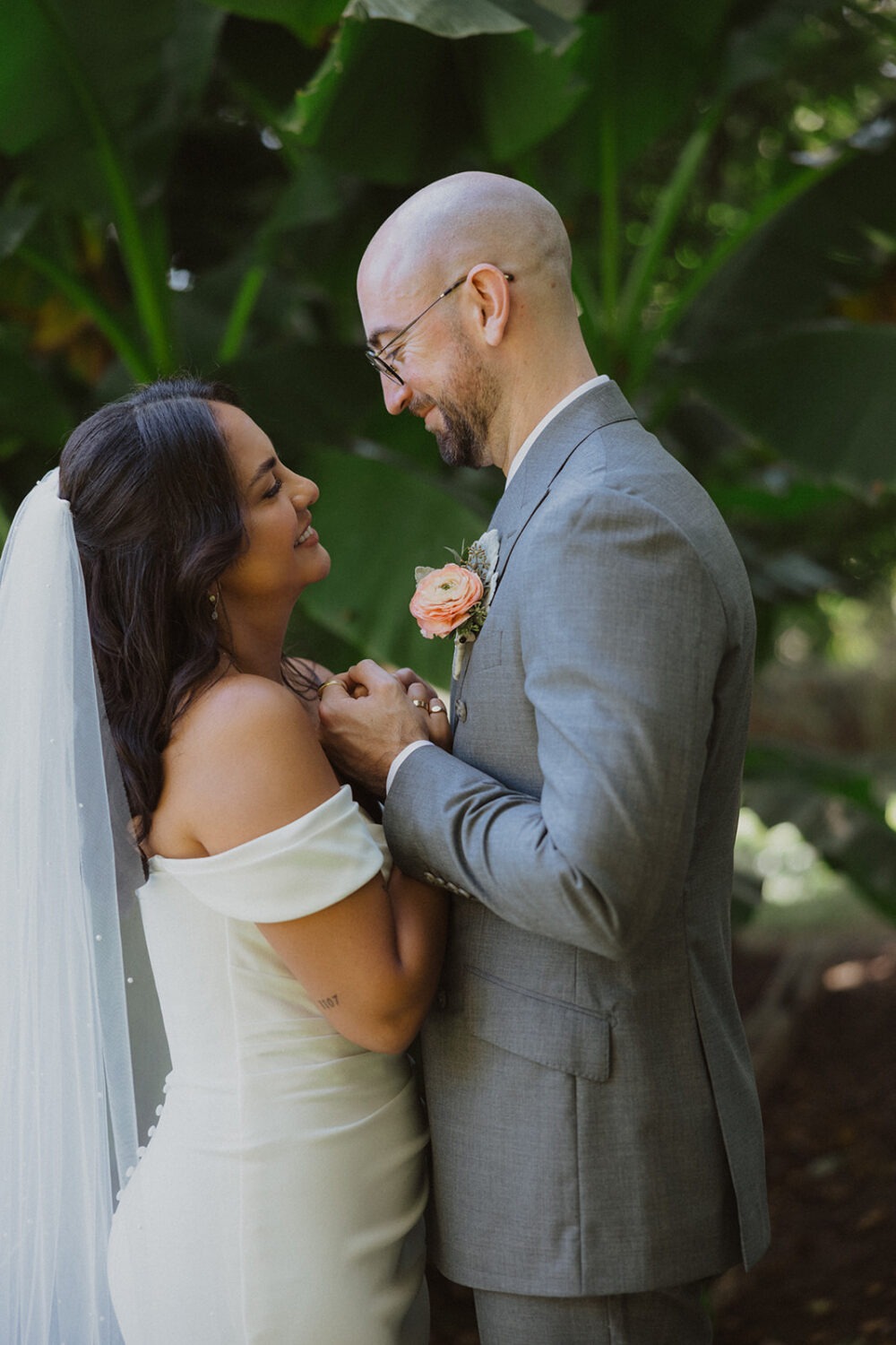 couple hold hands and look at each other in garden River Farm Alexandria Virginia
