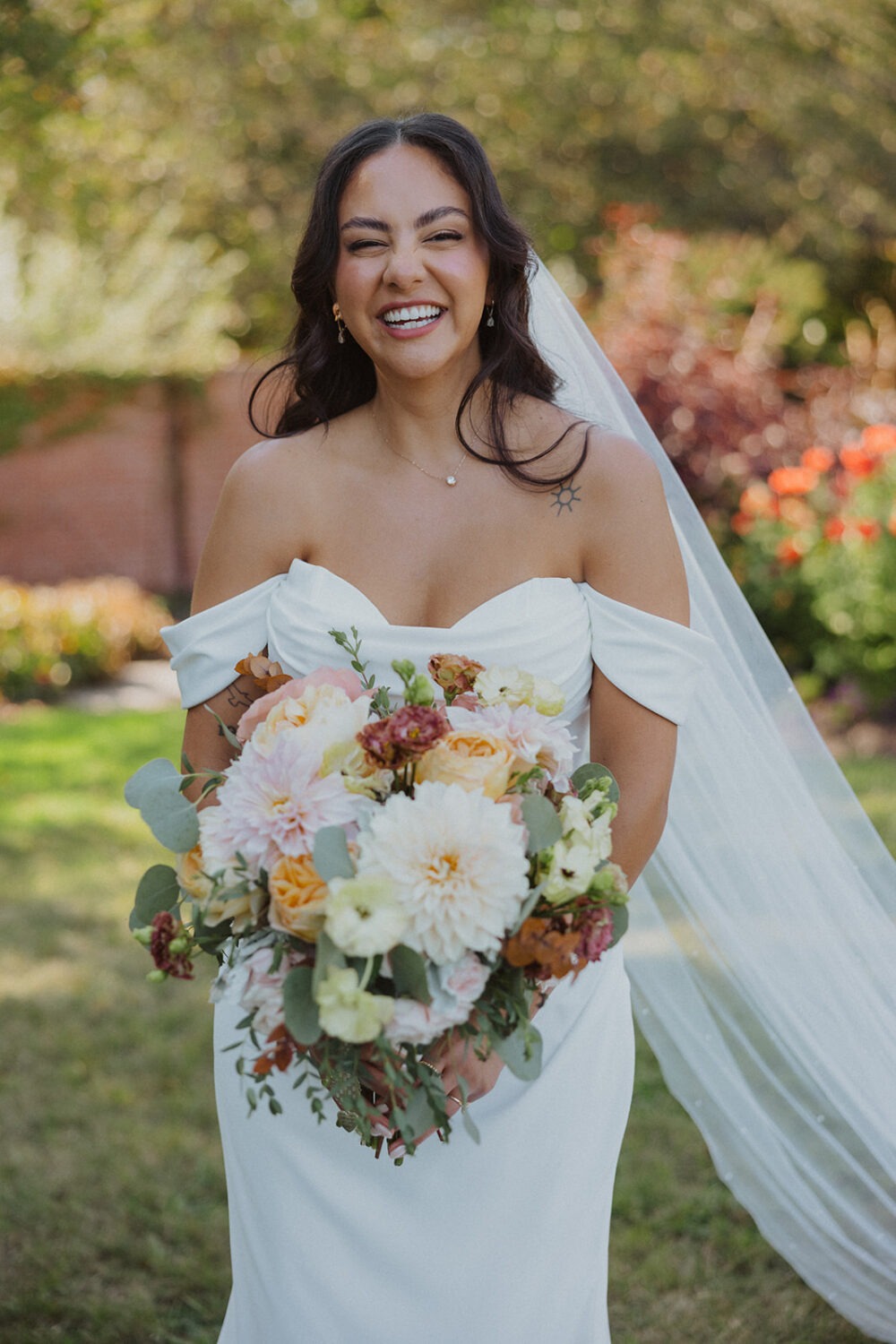 bridal portrait in the gardens while holding veil River Farm Alexandria Virginia