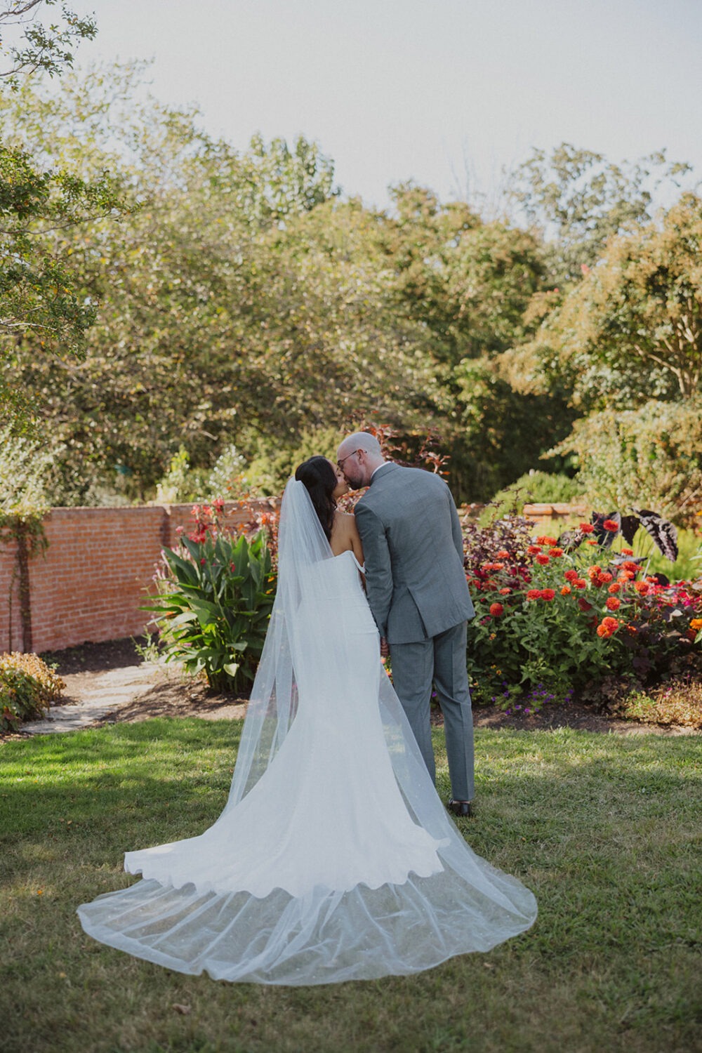 couple kiss in the gardens at River Farm Alexandria Virginia