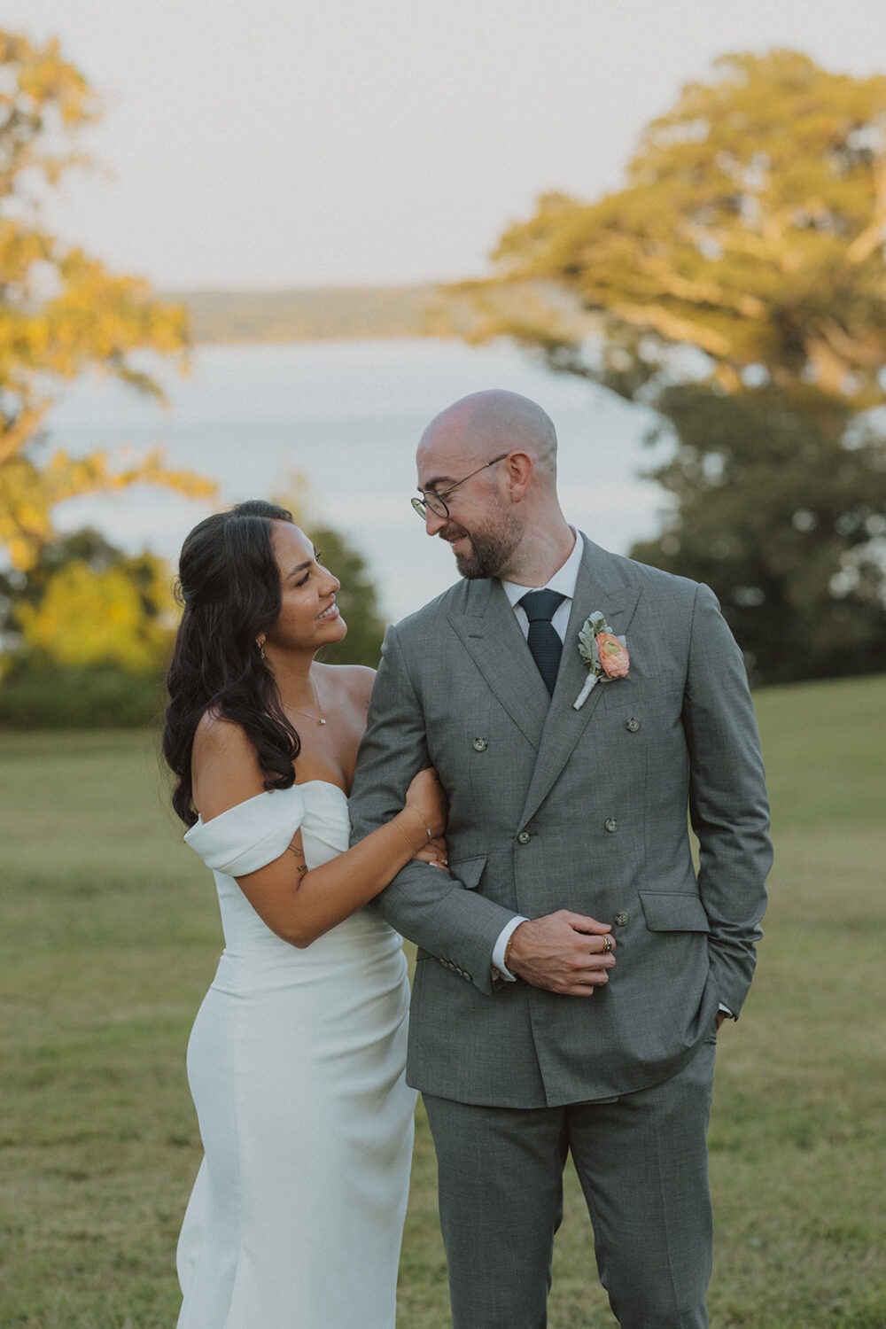 couple pose in front of the water during sunset at River Farm Alexandria Virginia