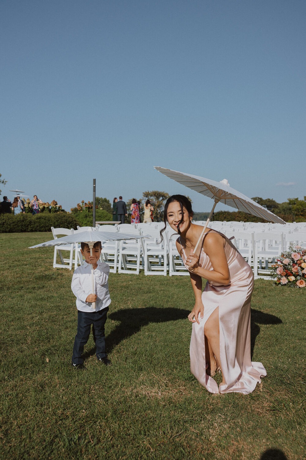 bridesmaid and ring bearer holding umbrellas